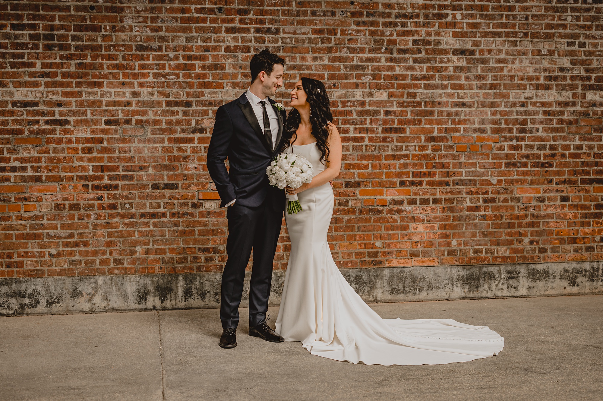 newlyweds hug leaning heads together during portraits at the Liberty House