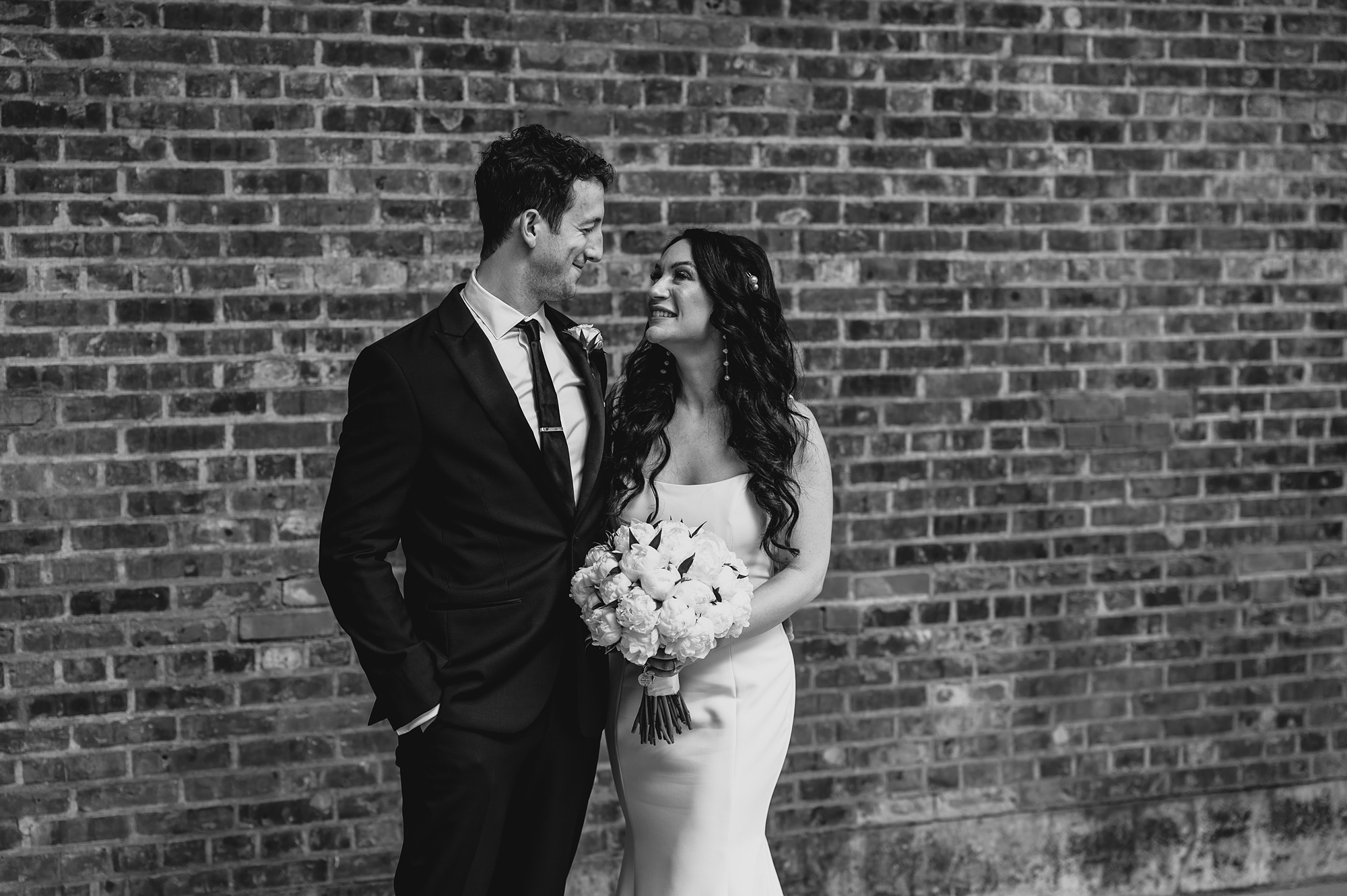 bride and groom hug during portraits at the Liberty House