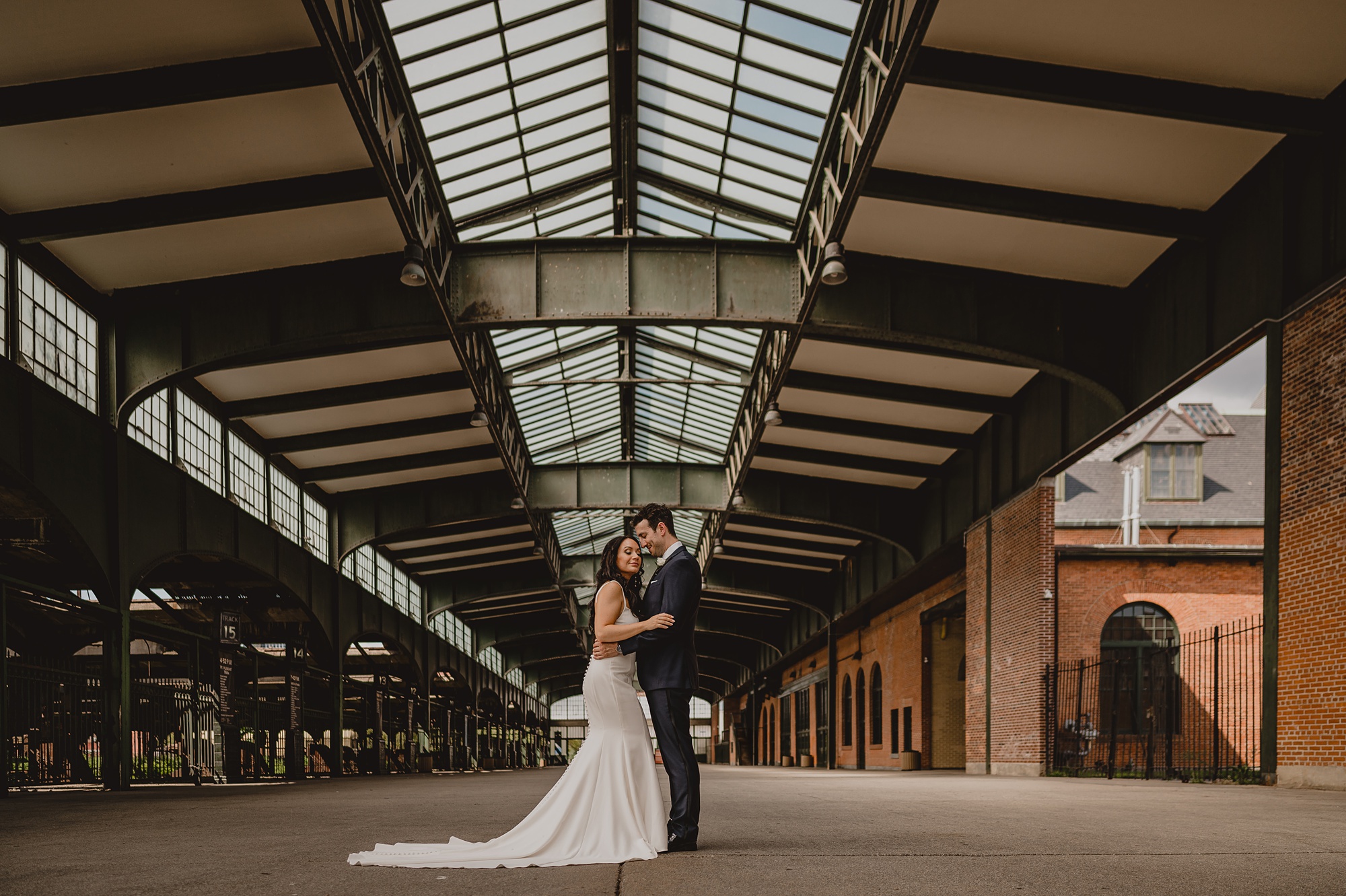 bride and groom hug in terminal at the Liberty House