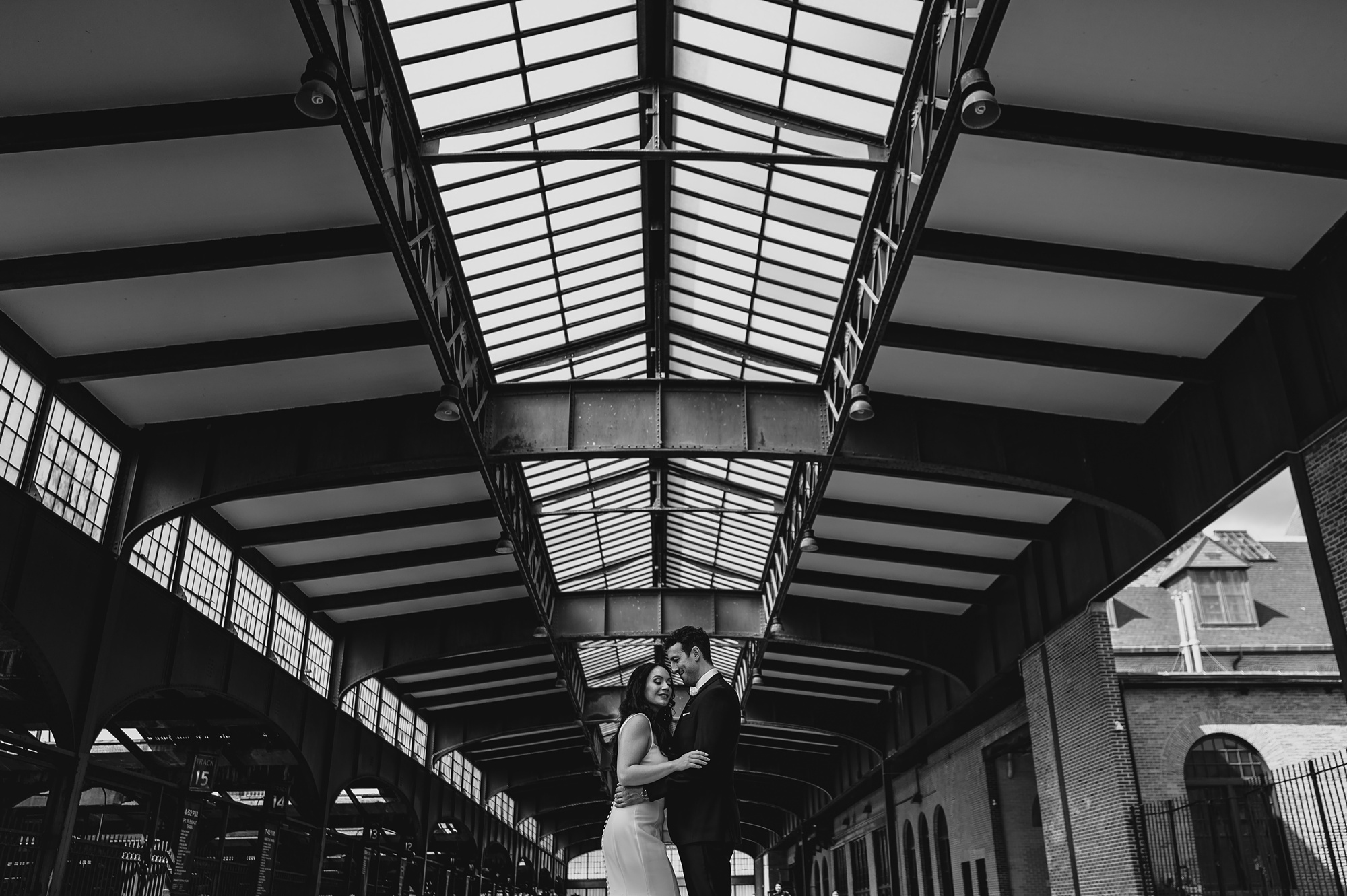 newlyweds hug under awning at the Liberty House