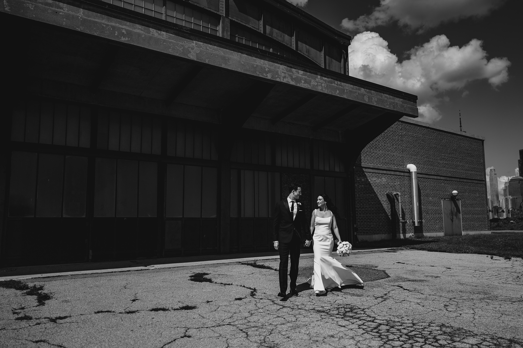 groom leads bride outside the Liberty House