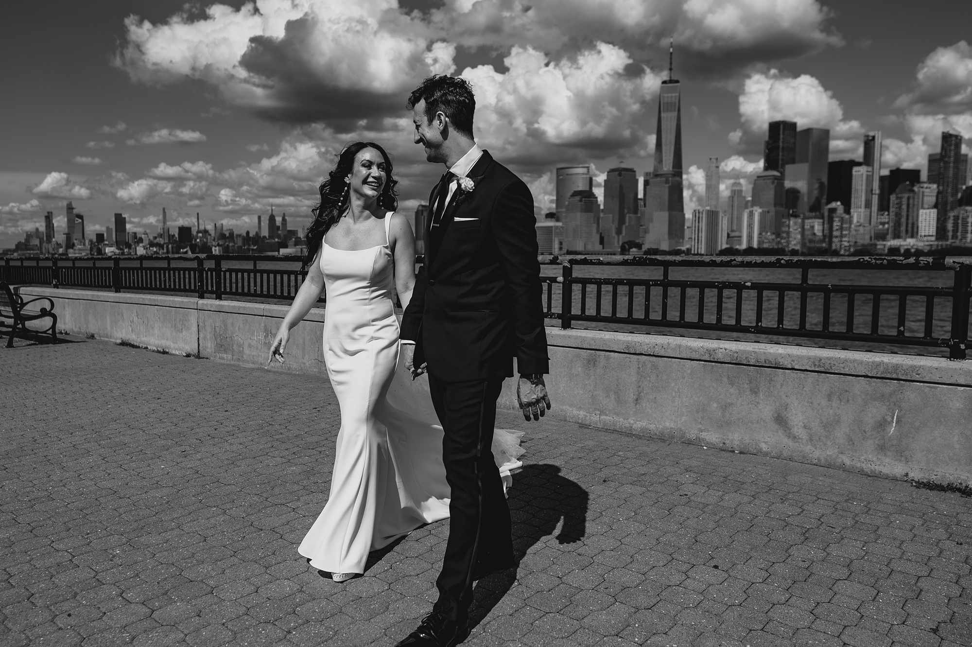 newlyweds walk in front of the Hudson River at the Liberty House