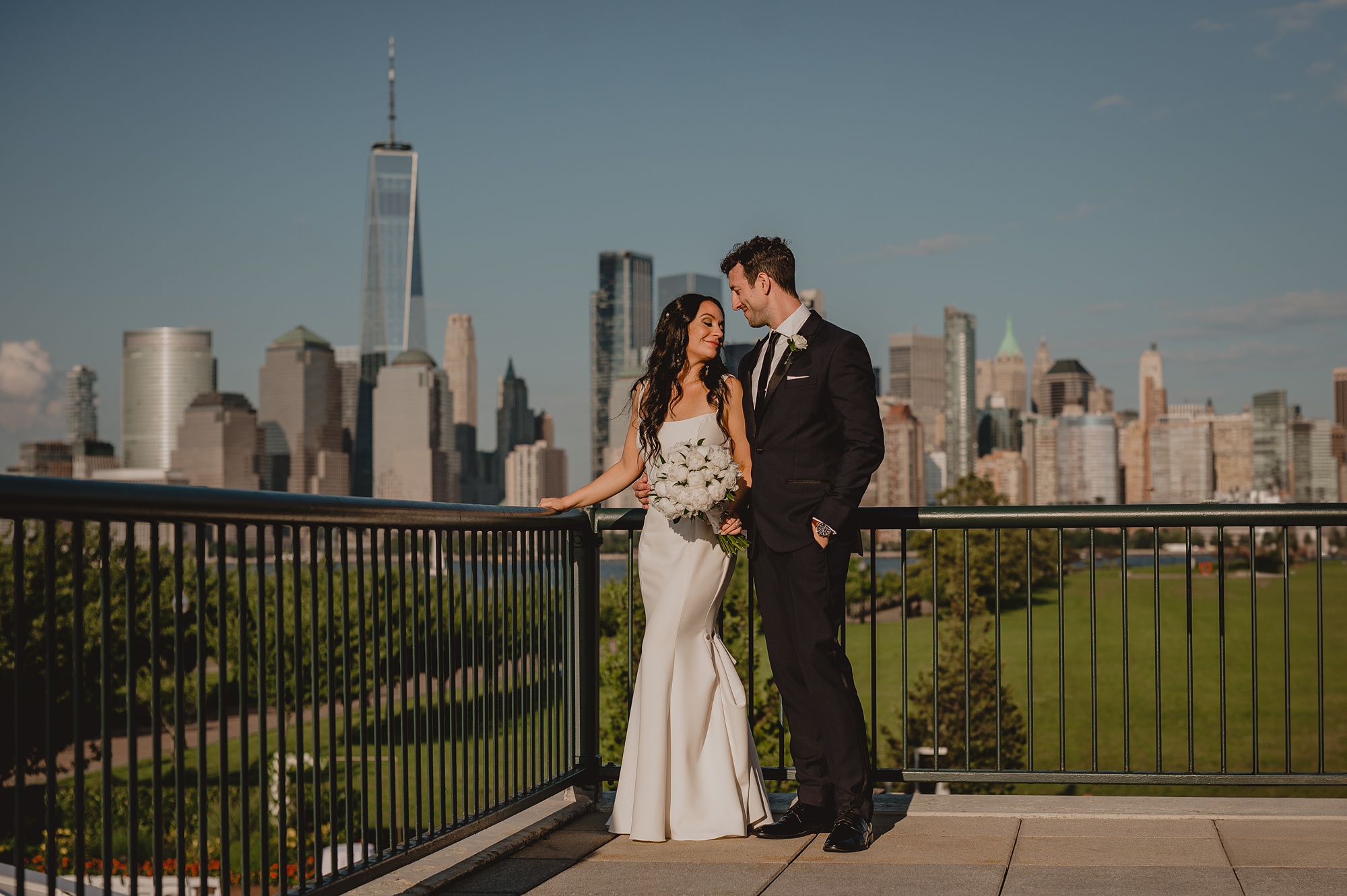 bride and groom hug in corner of patio at the Liberty House