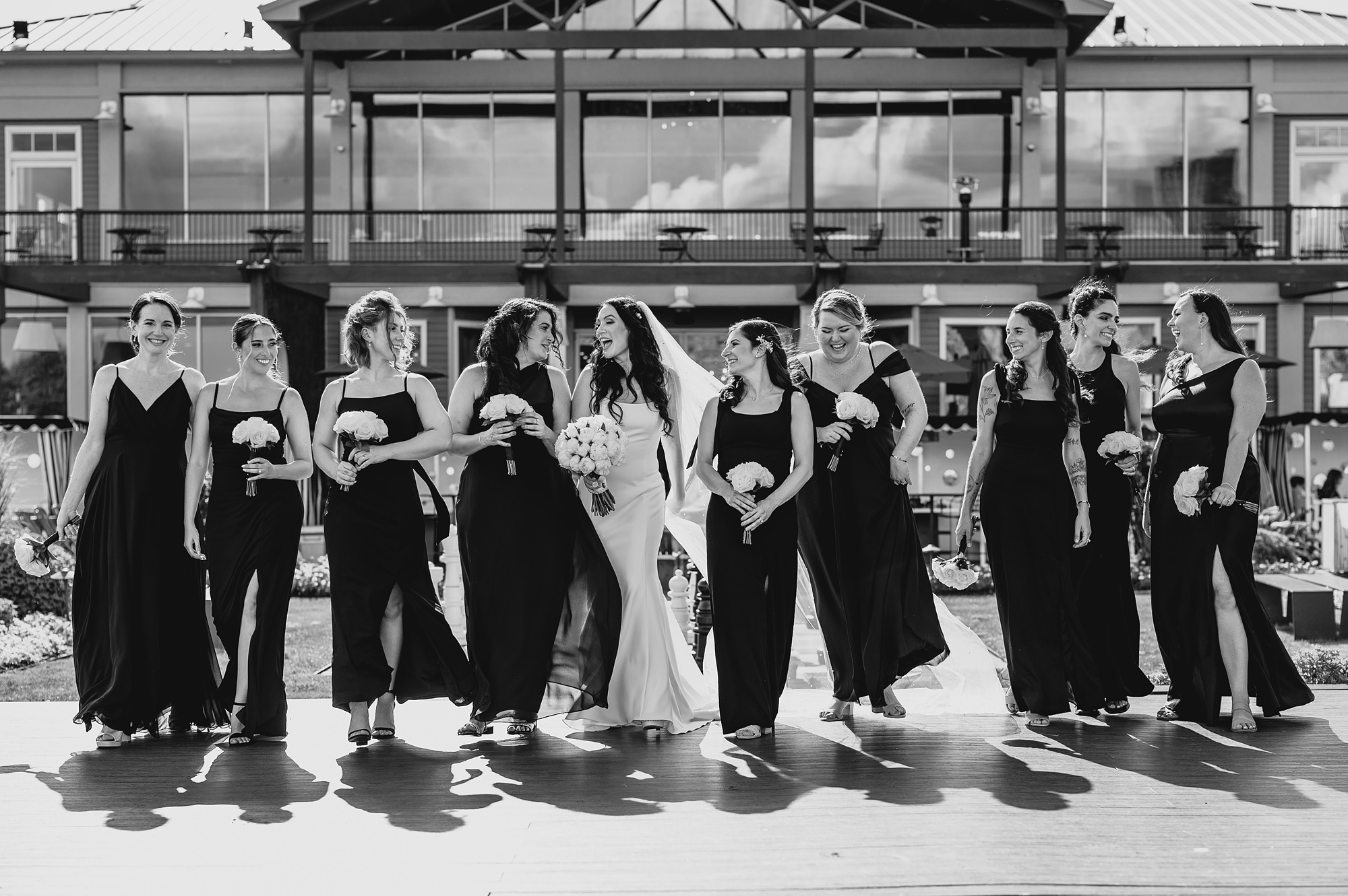 bride walks with bridesmaids in front of the Liberty House