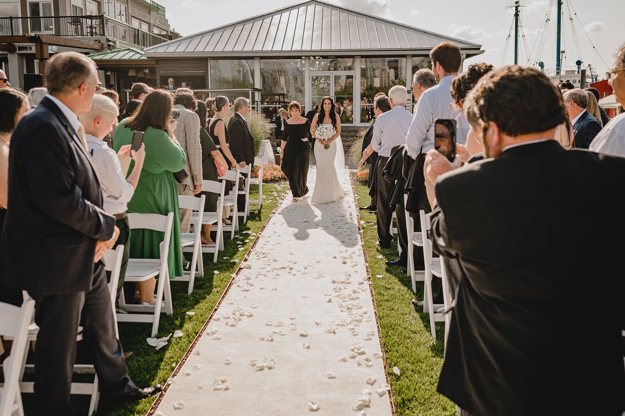 bride walks with mother down aisle at the Liberty House for wedding ceremony