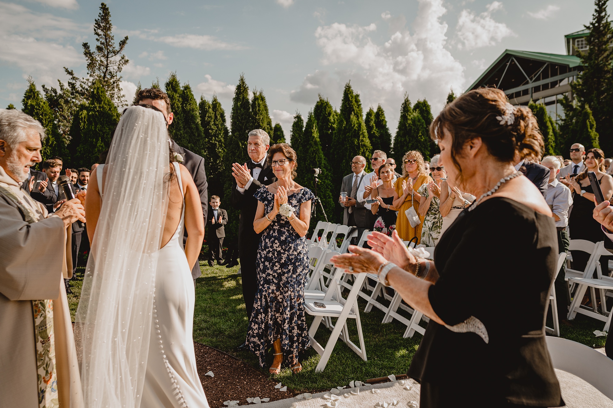 groom's parents smile at bride during wedding ceremony at the Liberty House