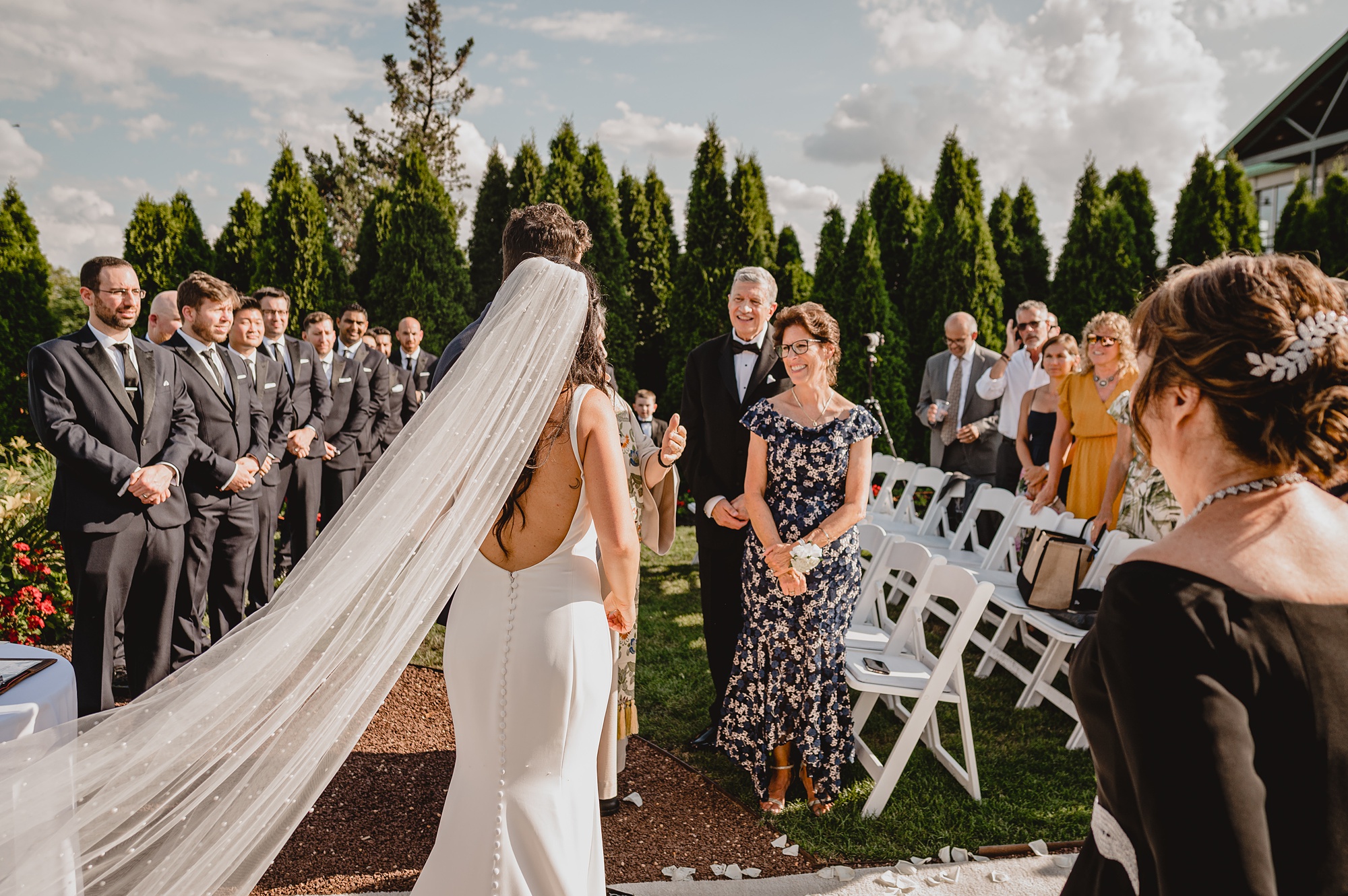 bride and groom smile at guest during wedding ceremony at the Liberty House