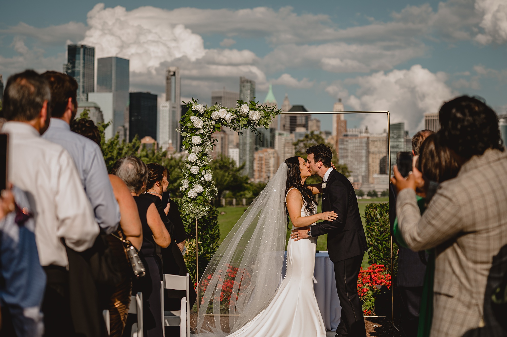 bride and groom kiss during wedding ceremony at the Liberty House