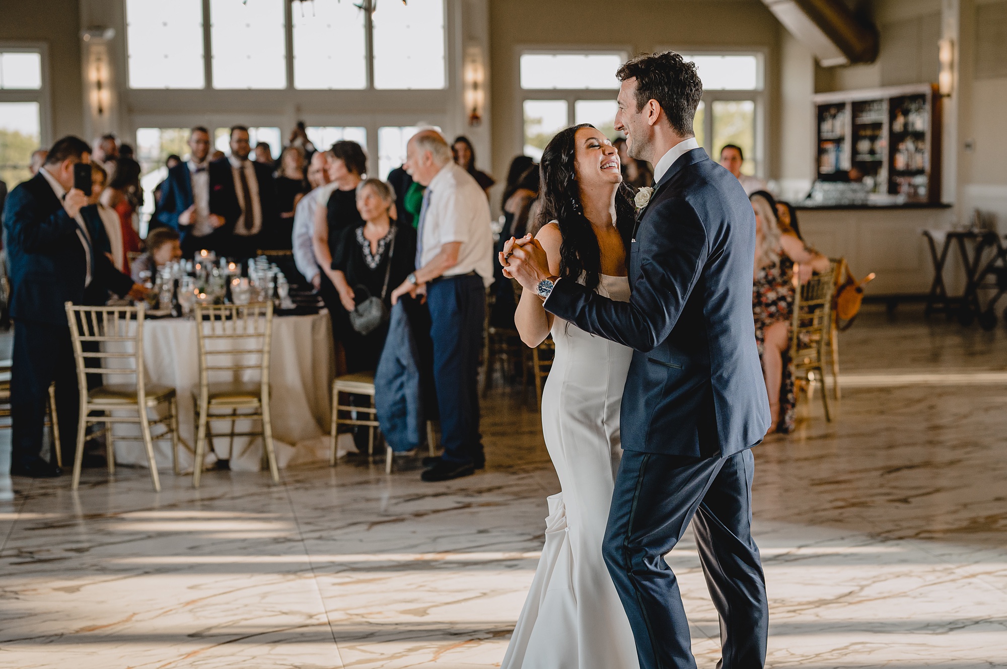 newlyweds smile dancing together during reception at the Liberty House