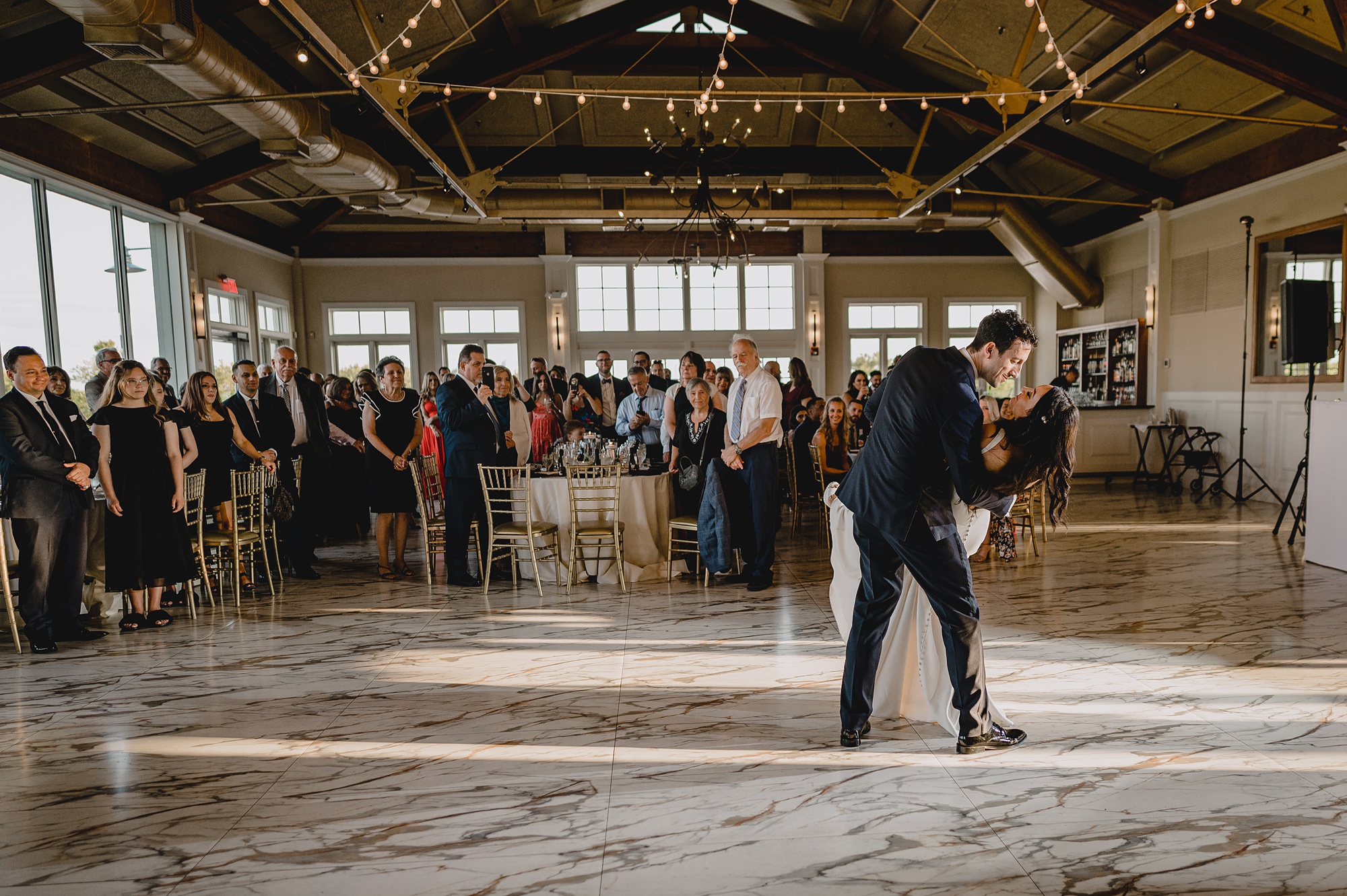 groom dips bride during reception at the Liberty House