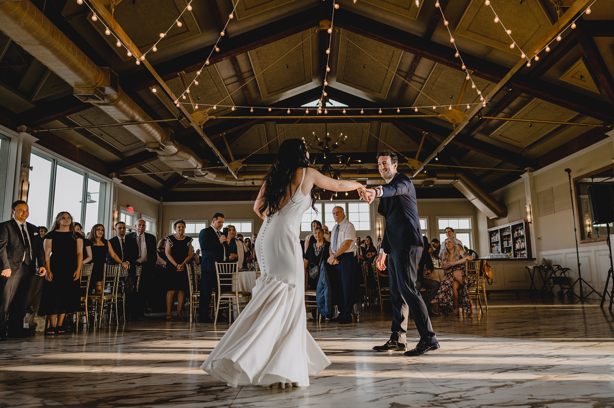 groom twirls bride on dance floor at the Liberty House