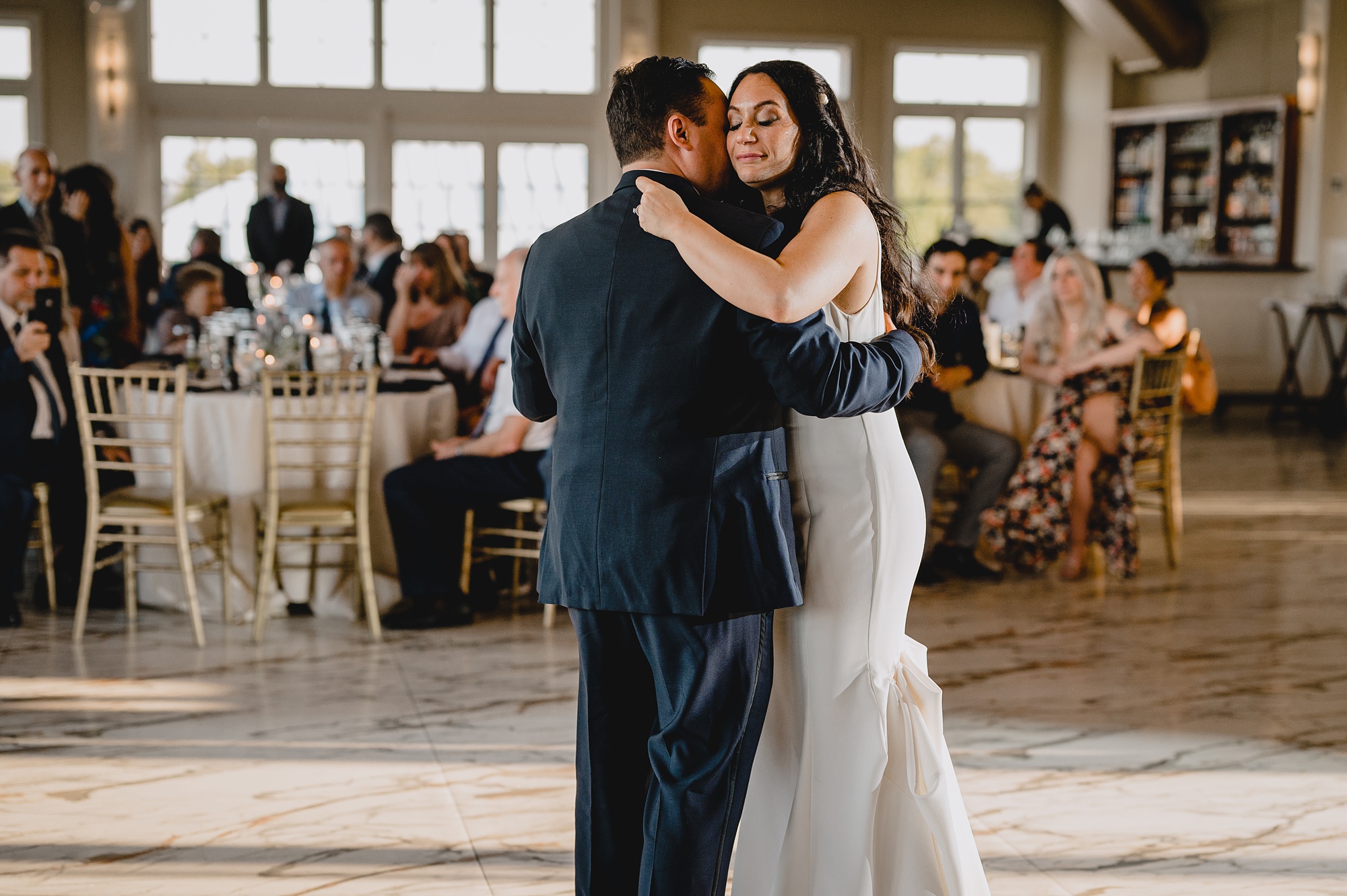 bride hugs father during reception at the Liberty House