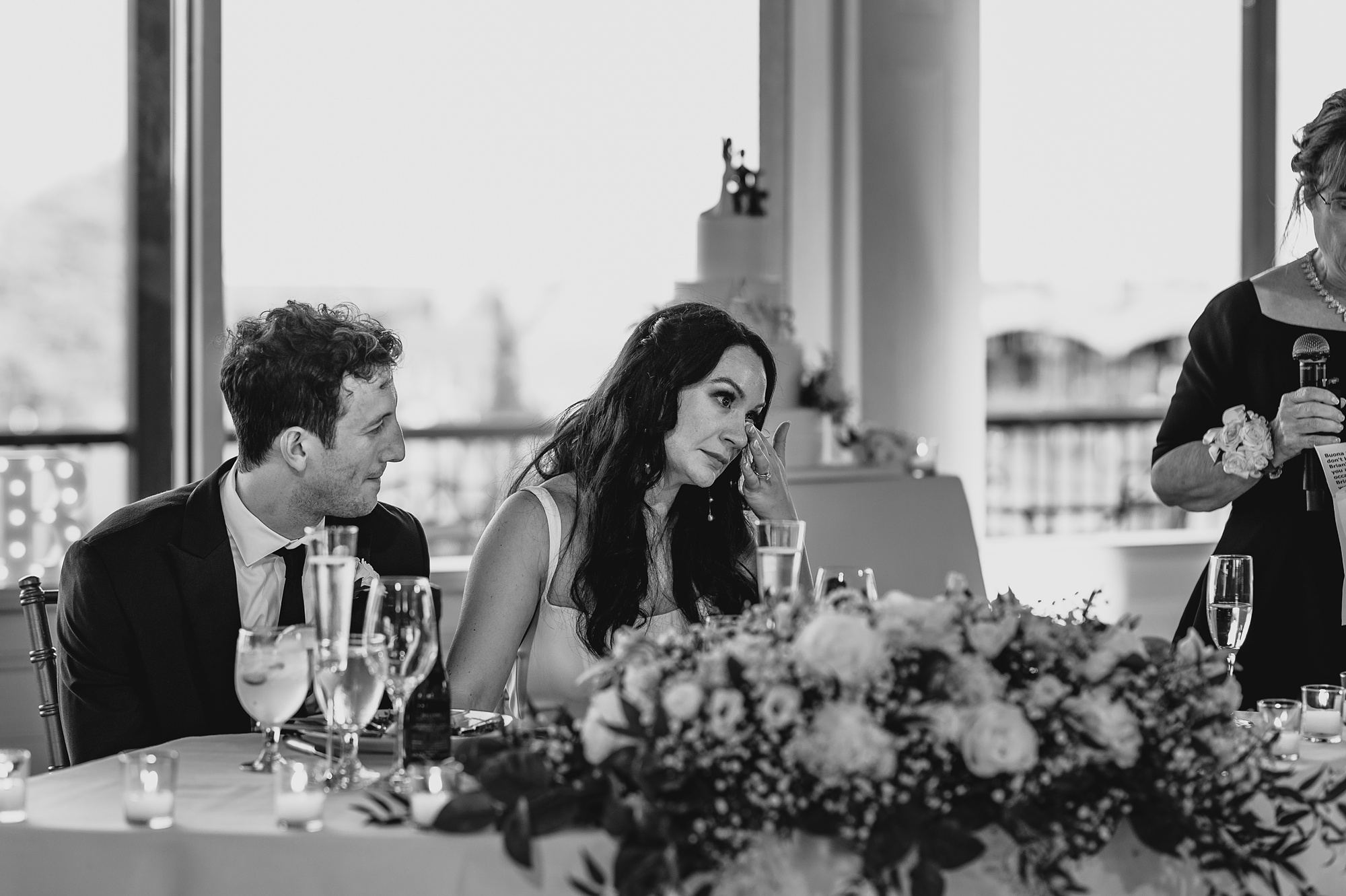 bride wipes away tear listening to speeches