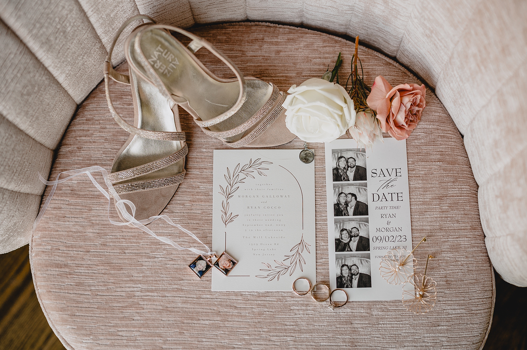 bride's shoes, invitation and roses on top of chair