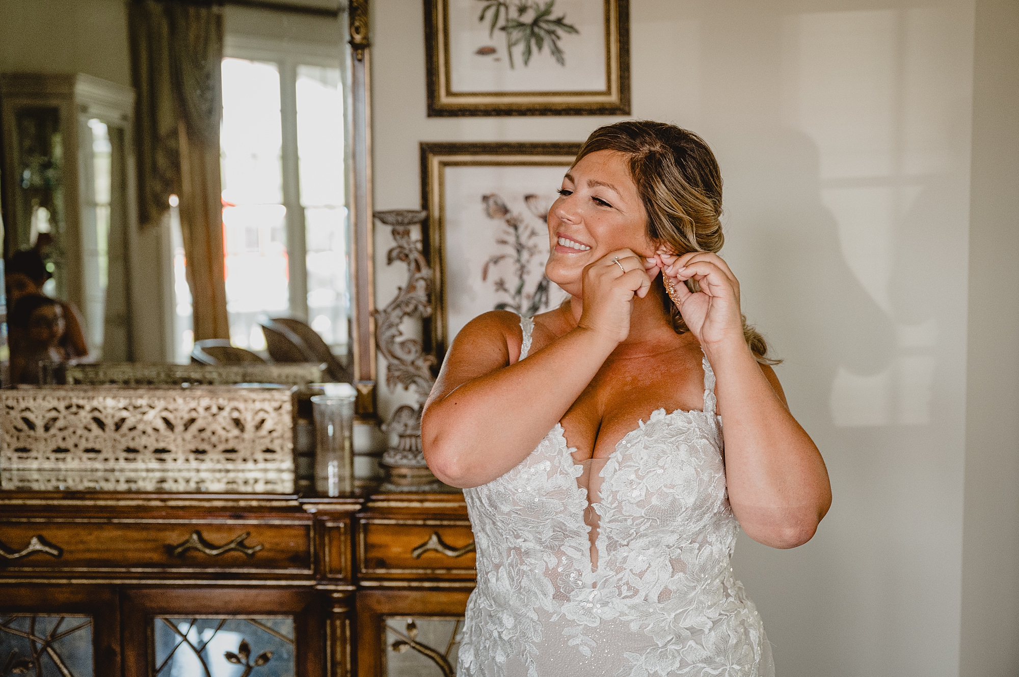 bride adjusts earrings in suite at the Mill Lakeside Manor