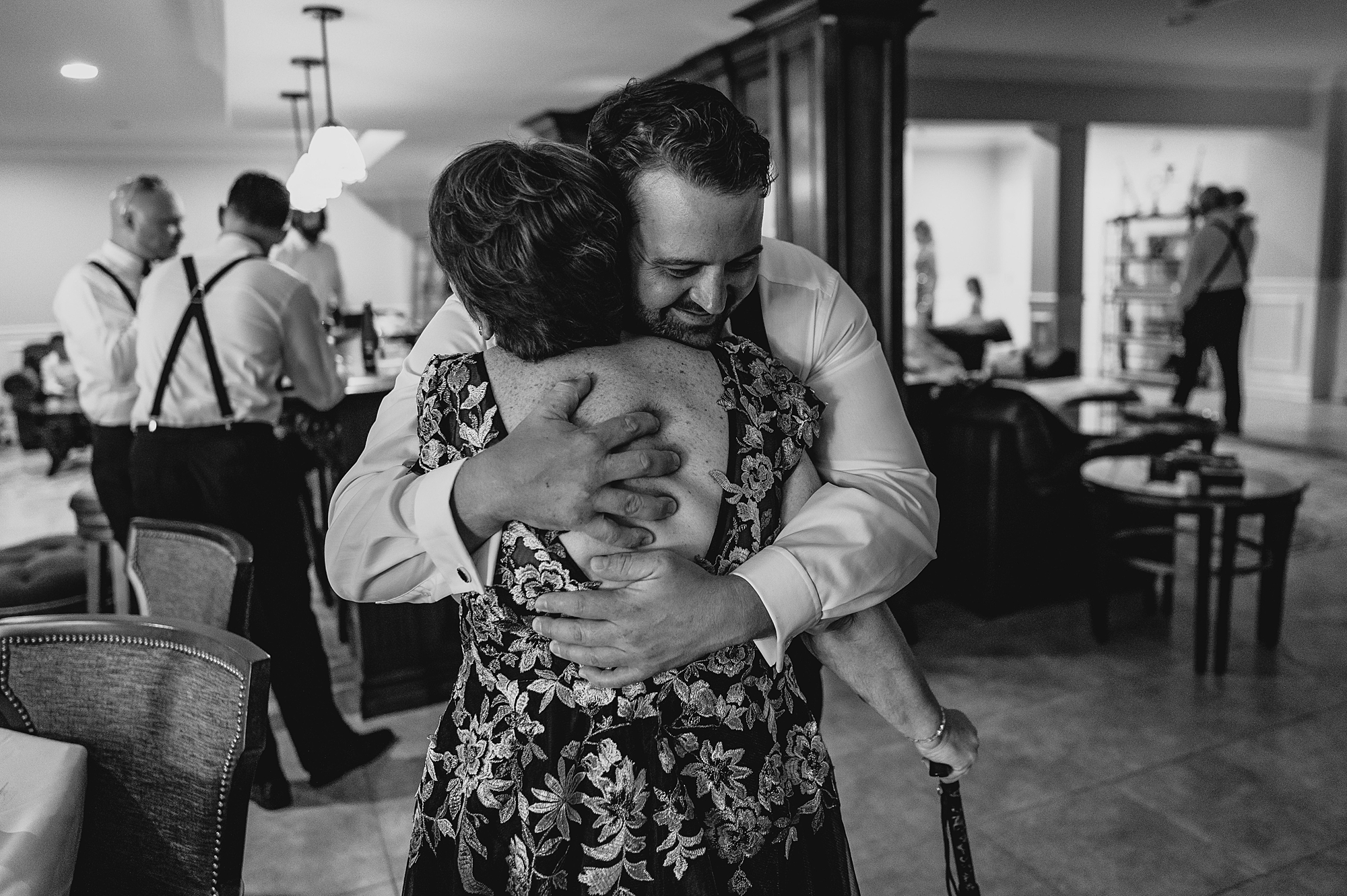 groom hugs mom during prep at the Mill Lakeside Manor