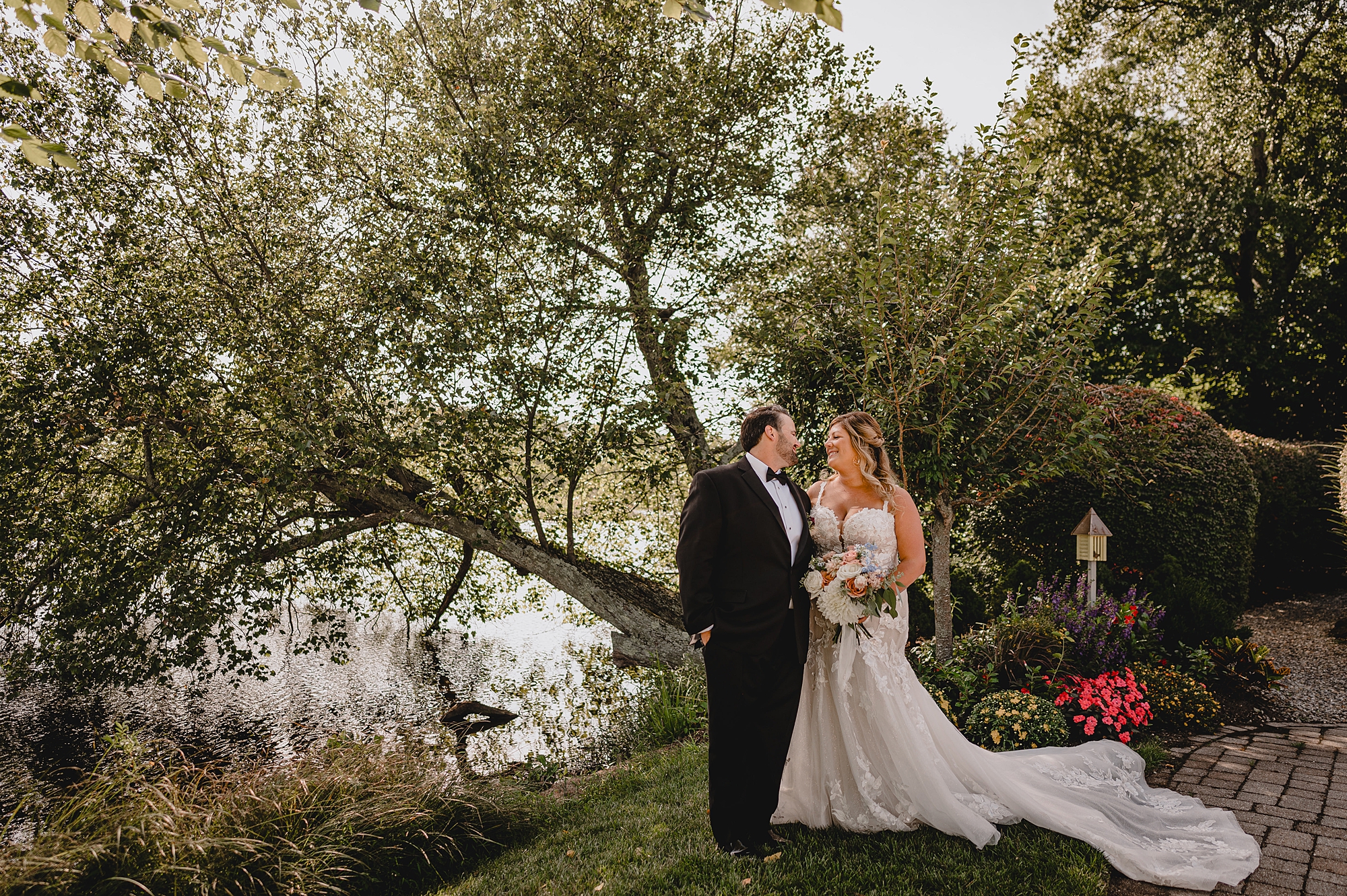 bride and groom hug in gardens of NJ wedding venue