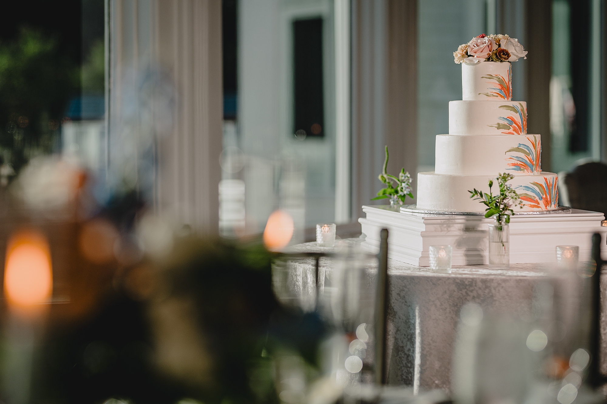 tiered wedding cake with flowers on top tier