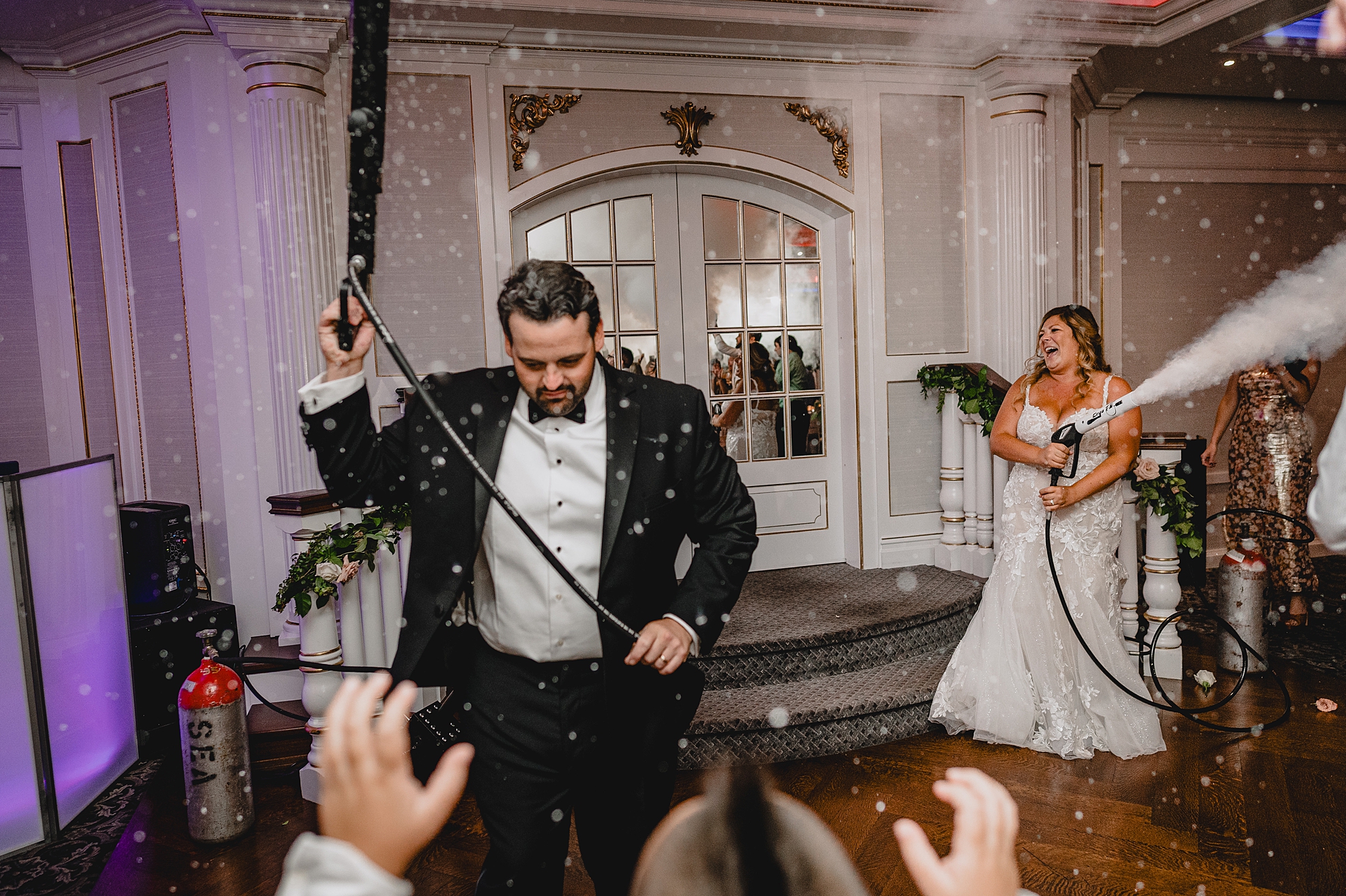 groom and bride use fog machines during Spring Lake NJ wedding reception