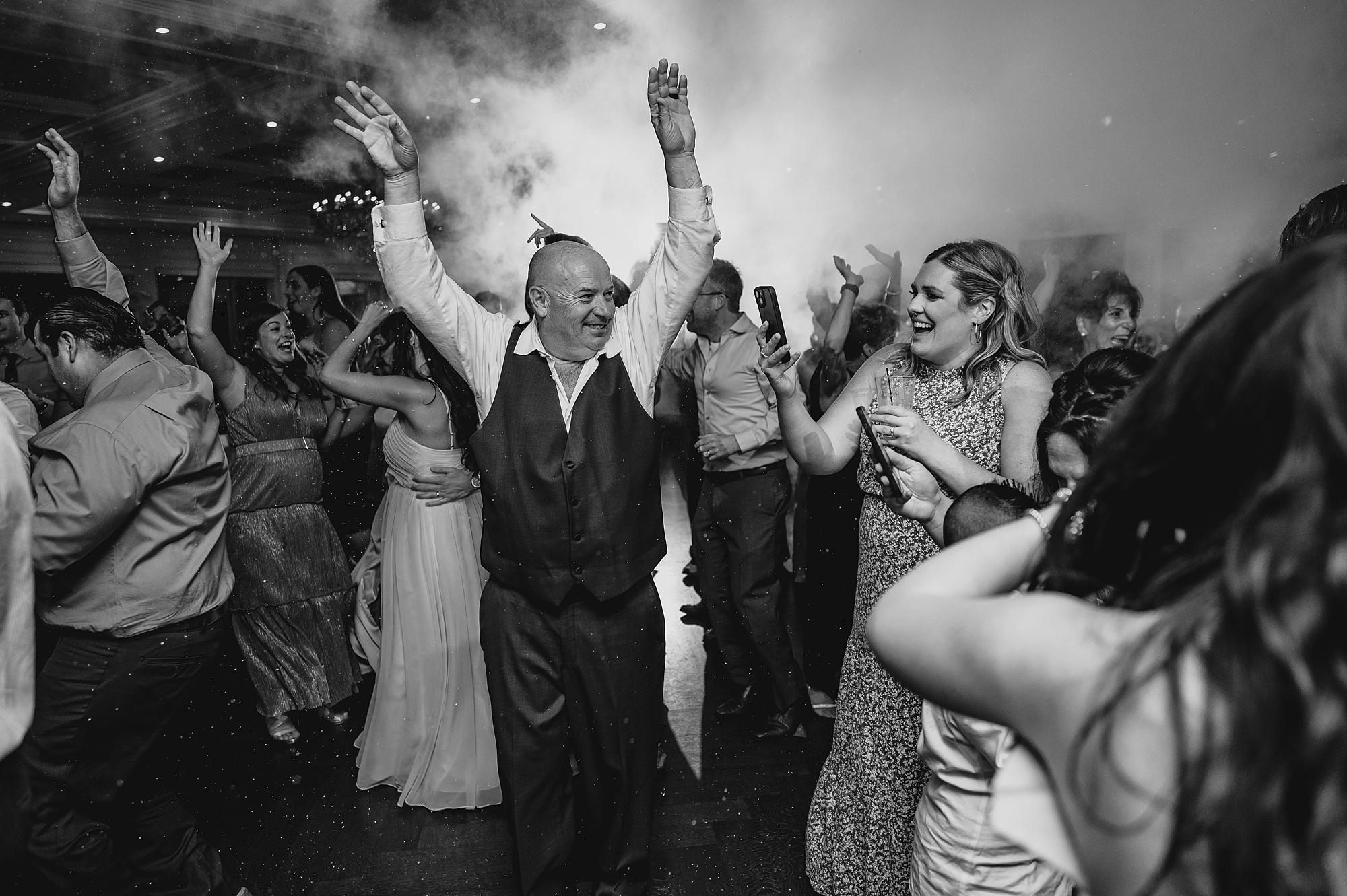 wedding guests dance under fog at Spring Lake NJ wedding reception