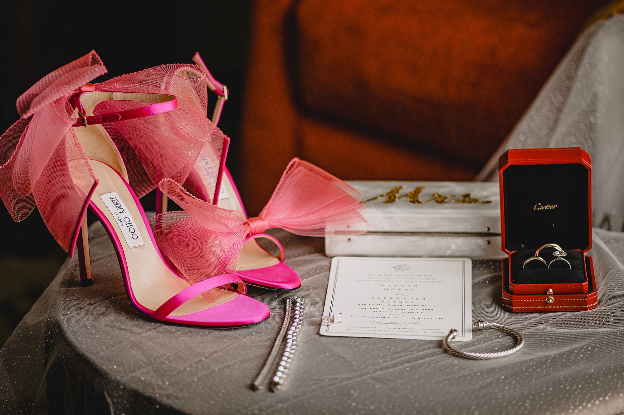 bride's pink shoes, jewelry in red box, and stationary for New York wedding