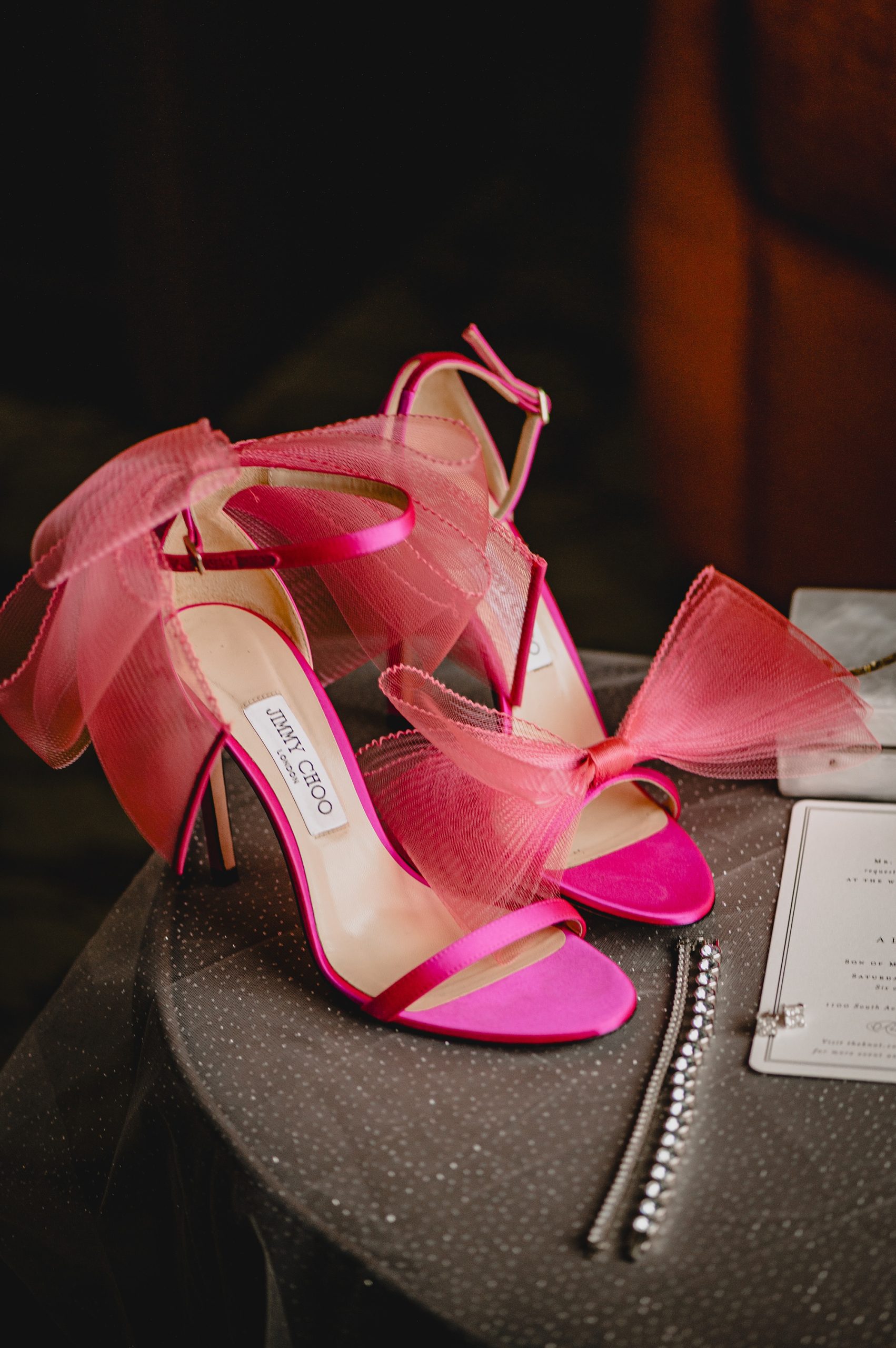 bride's pink shoes next to jewelry