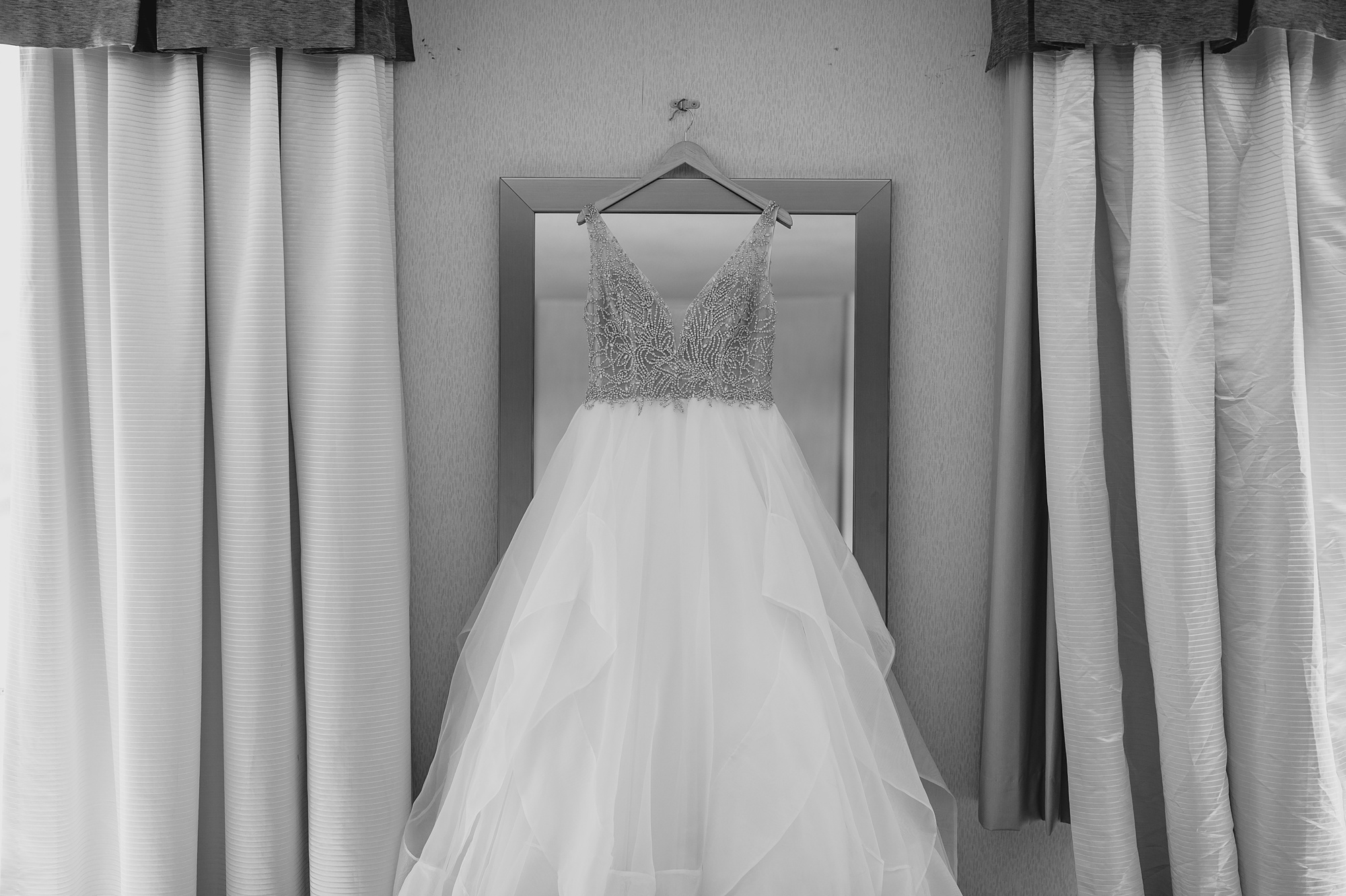 wedding dress hangs on mirror in Staten Island hotel