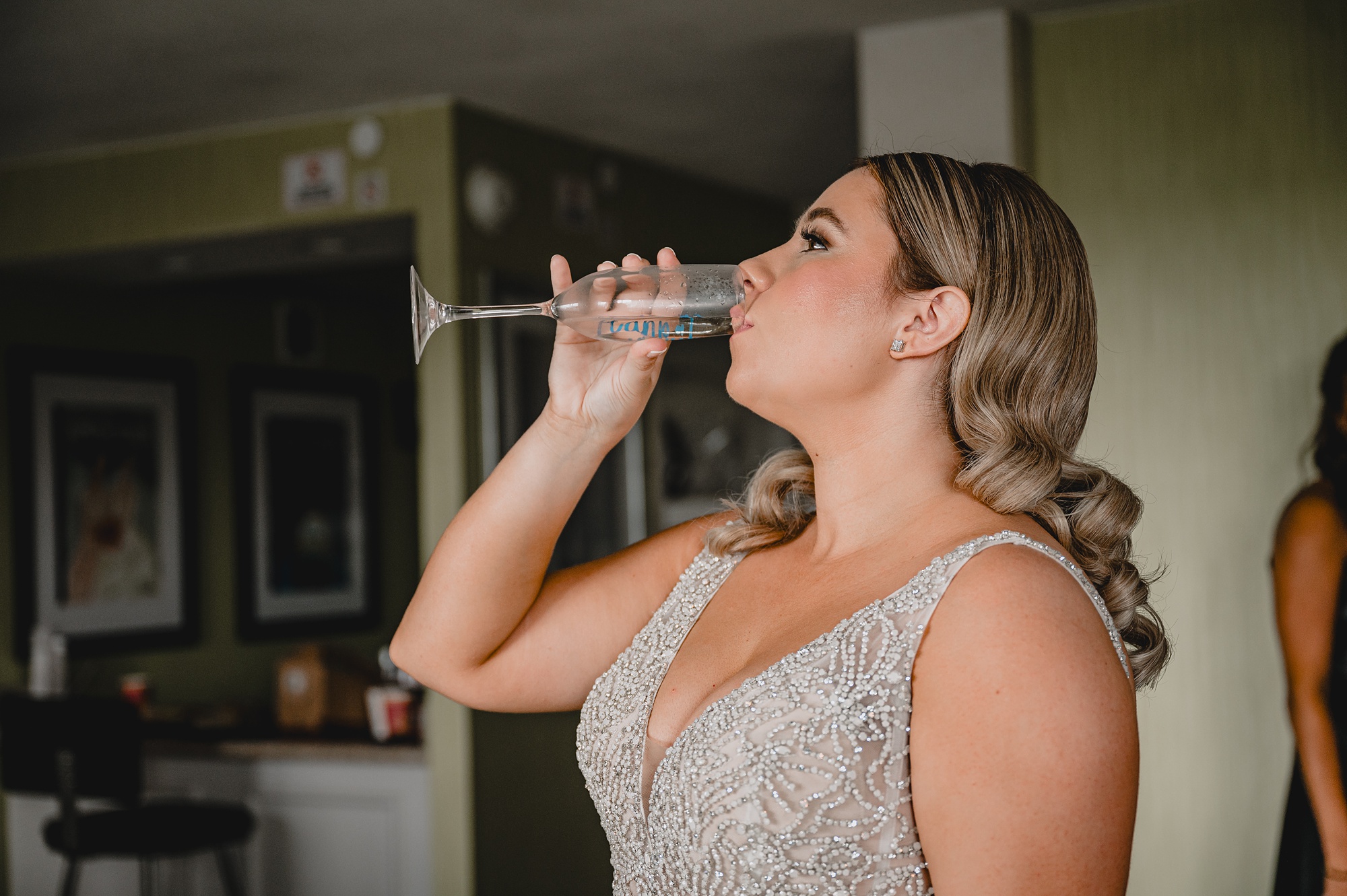 bride drinks champagne in hotel room in Staten Island