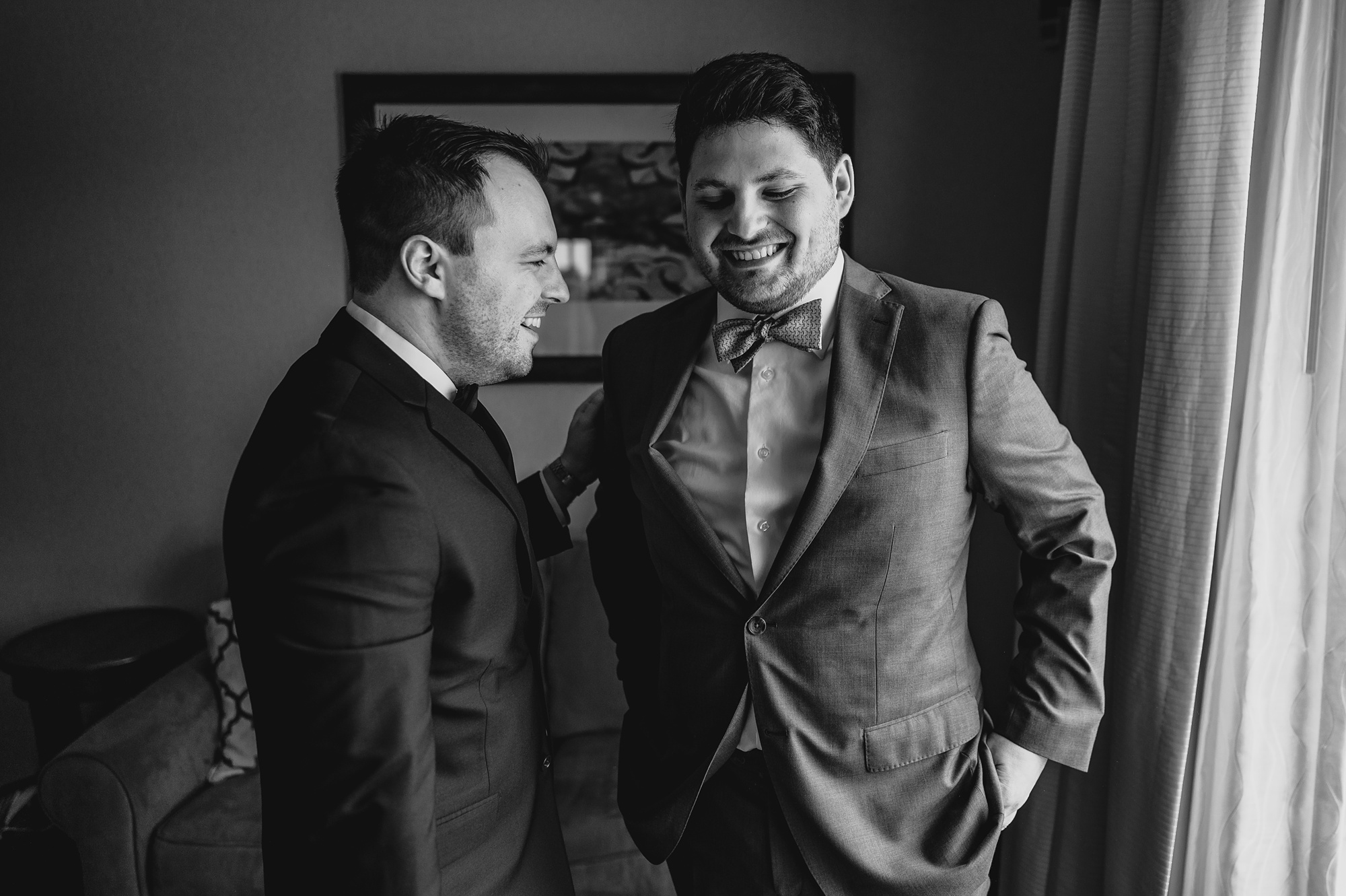 groomsman talks with groom during prep at Staten Island hotel