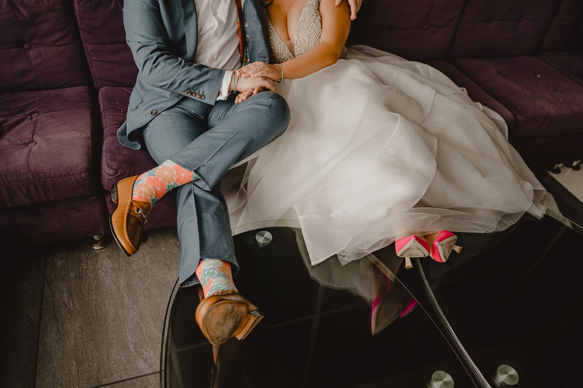 bride and groom hold hands of sofa at Above Staten Island