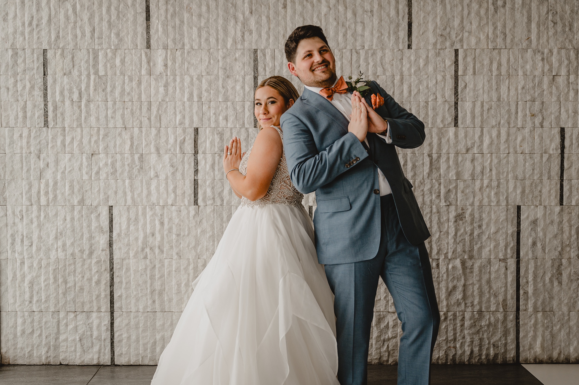 newlyweds hug back to back outside Above Staten Island