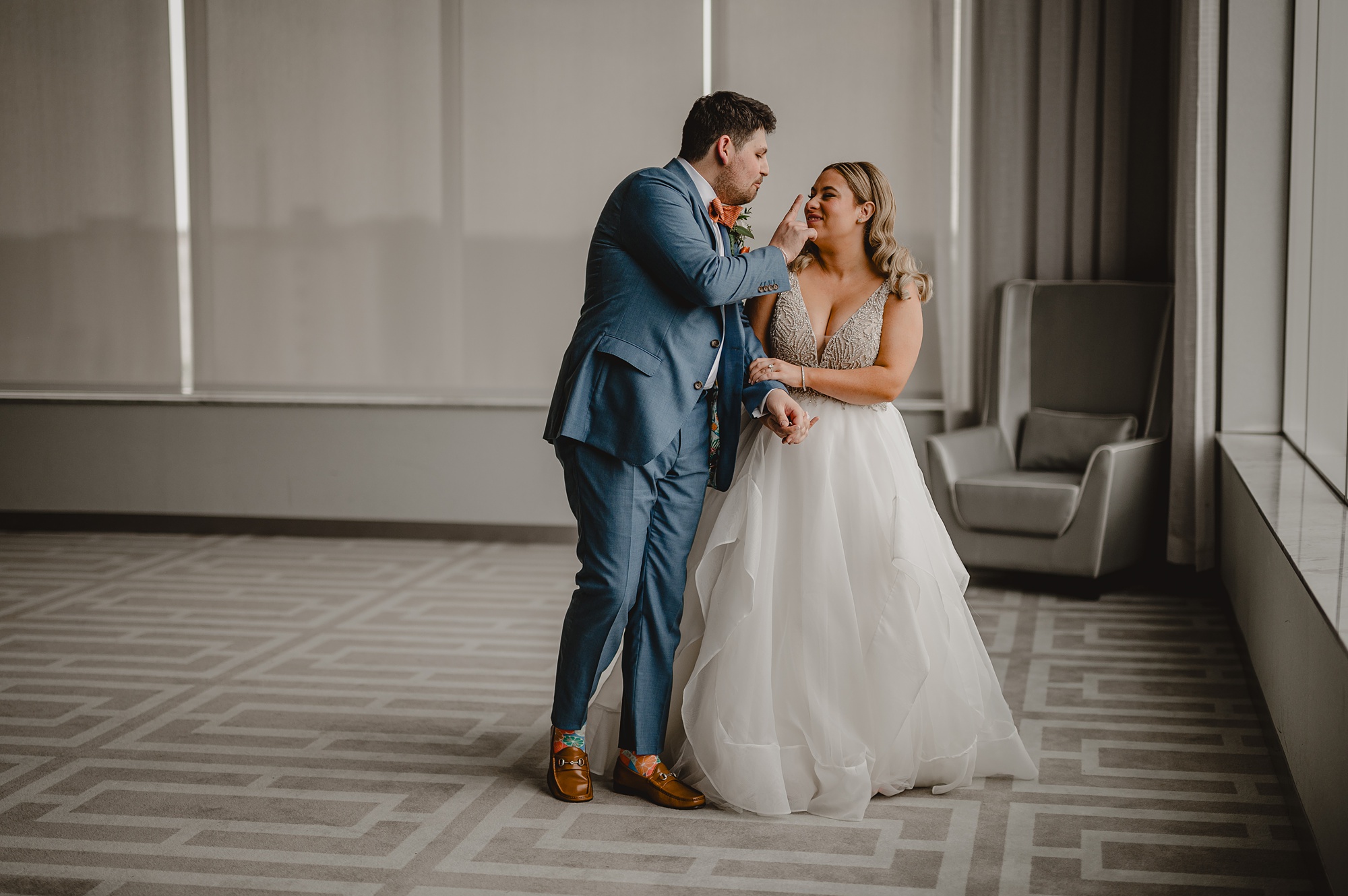 newlyweds dance in front of windows at Above Staten Island