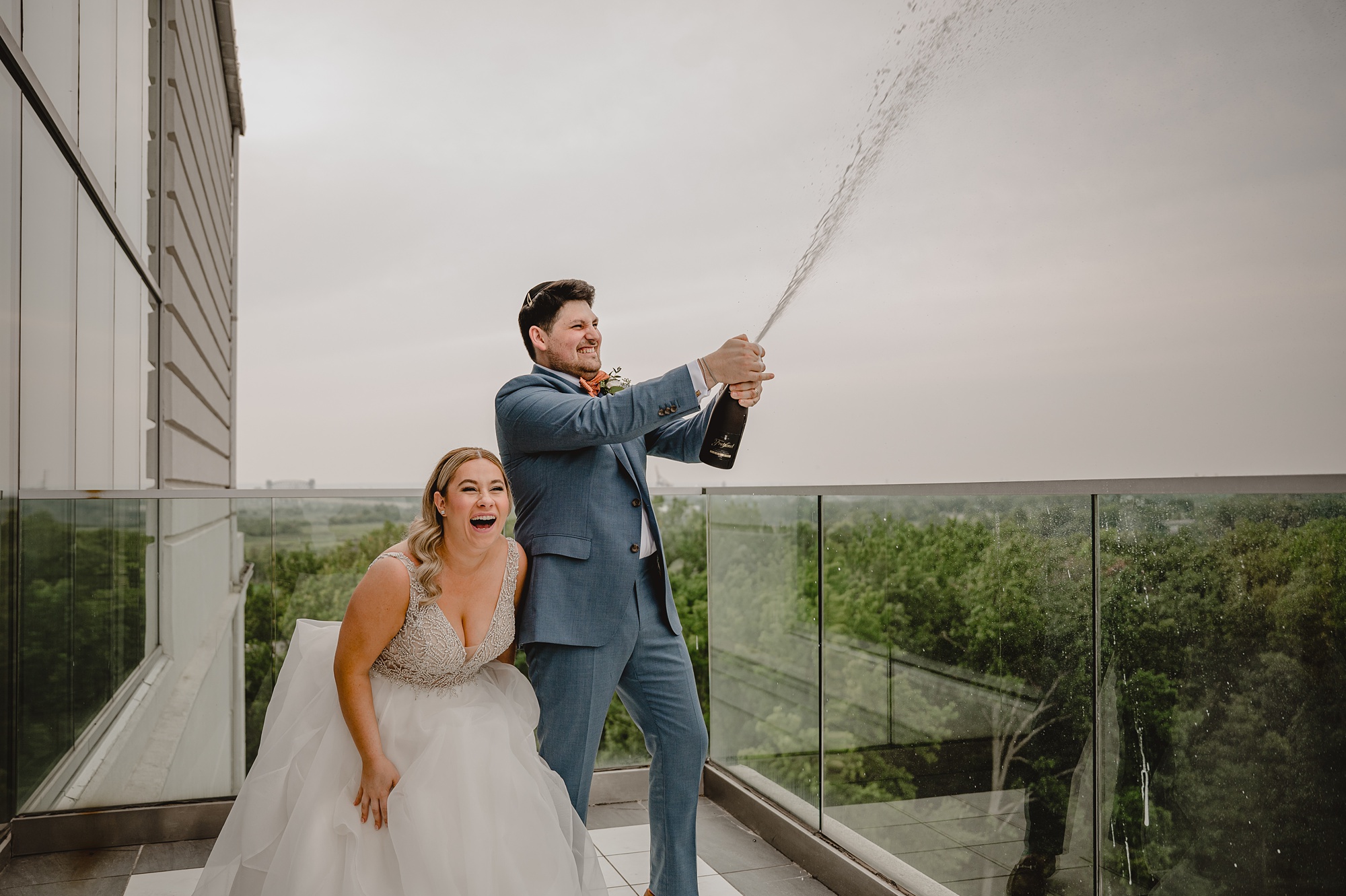 bride laughs during champagne toast on rooftop at Above Staten Island