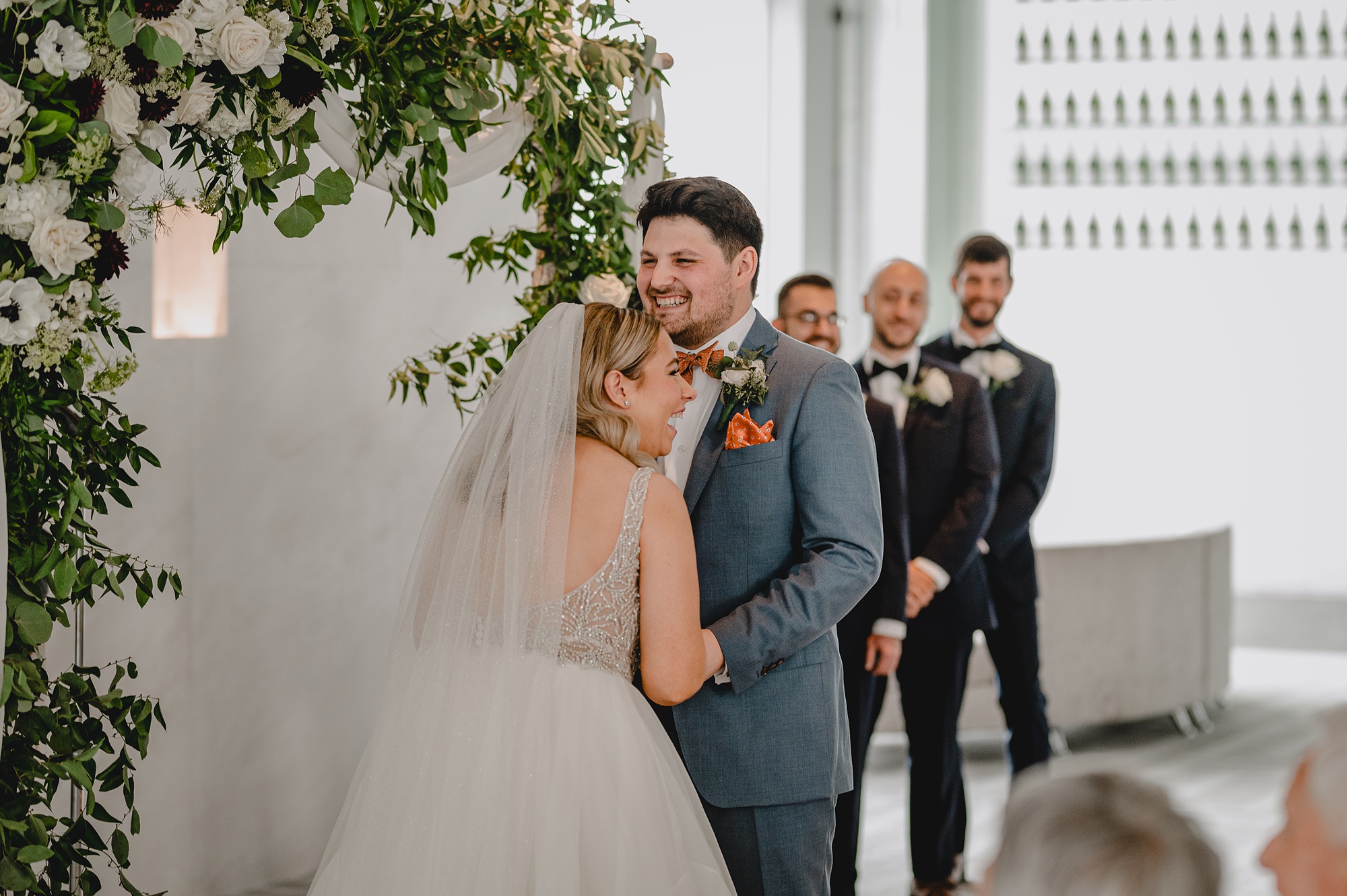 bride leans against groom during wedding ceremony at Above Staten Island