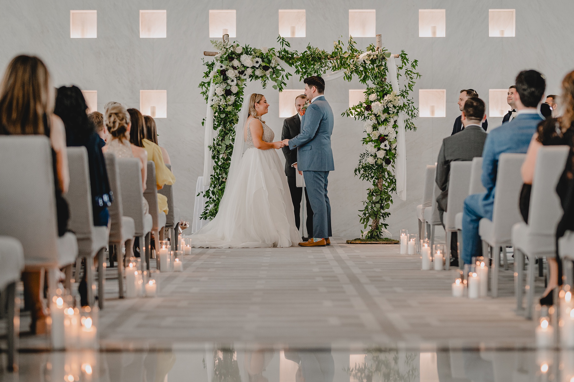 bride and groom hold hands during wedding ceremony at Above Staten Island