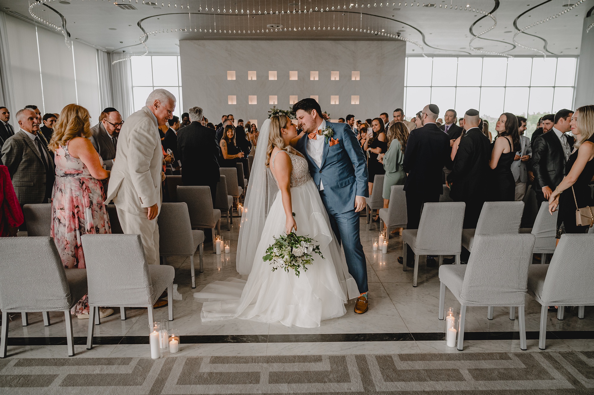 bride and groom kiss in aisle following wedding ceremony at Above Staten Island