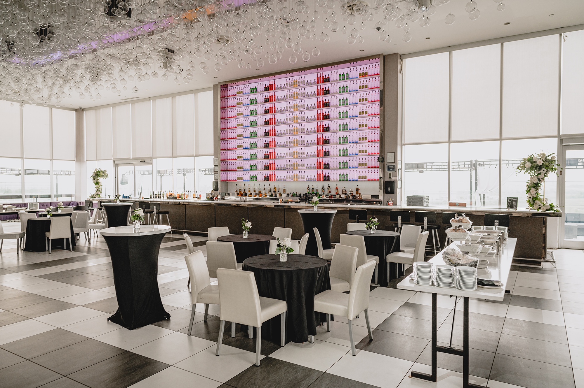 wedding reception in front of bar with white and black details at Above Staten Island