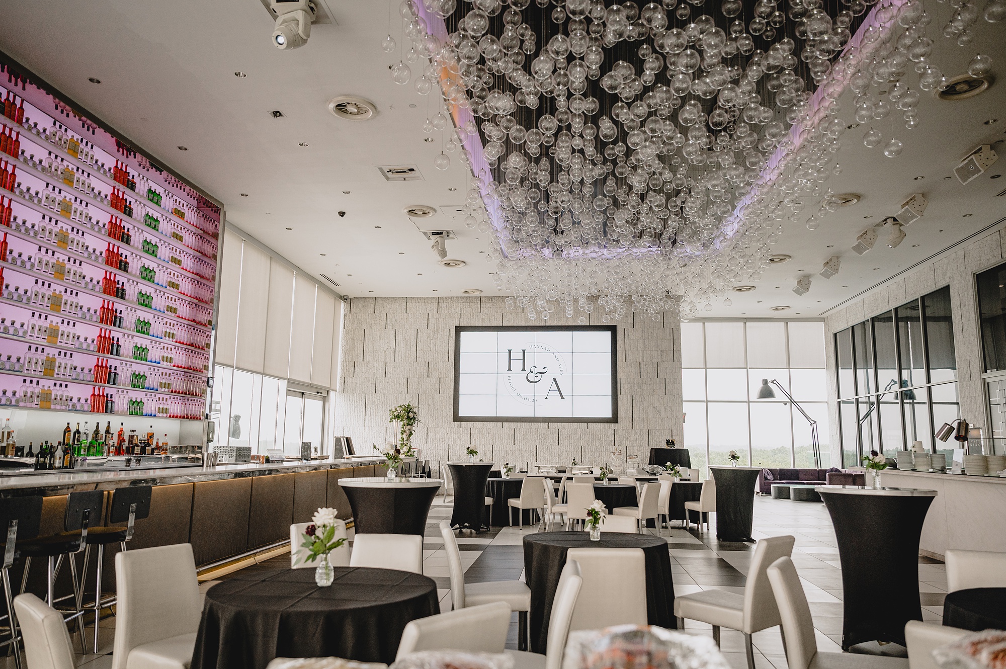 wedding reception in front of bar with white and black details at Above Staten Island