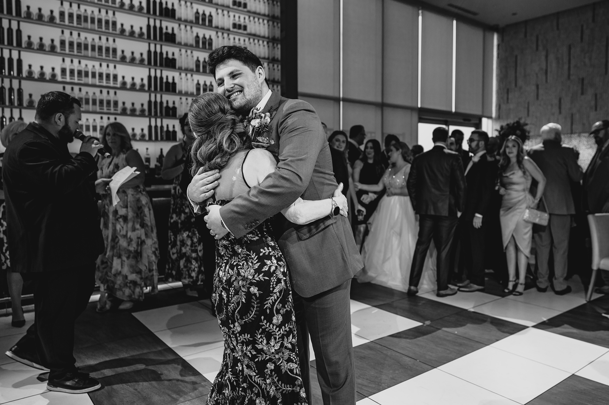 groom hugs mom during dance at Above Staten Island