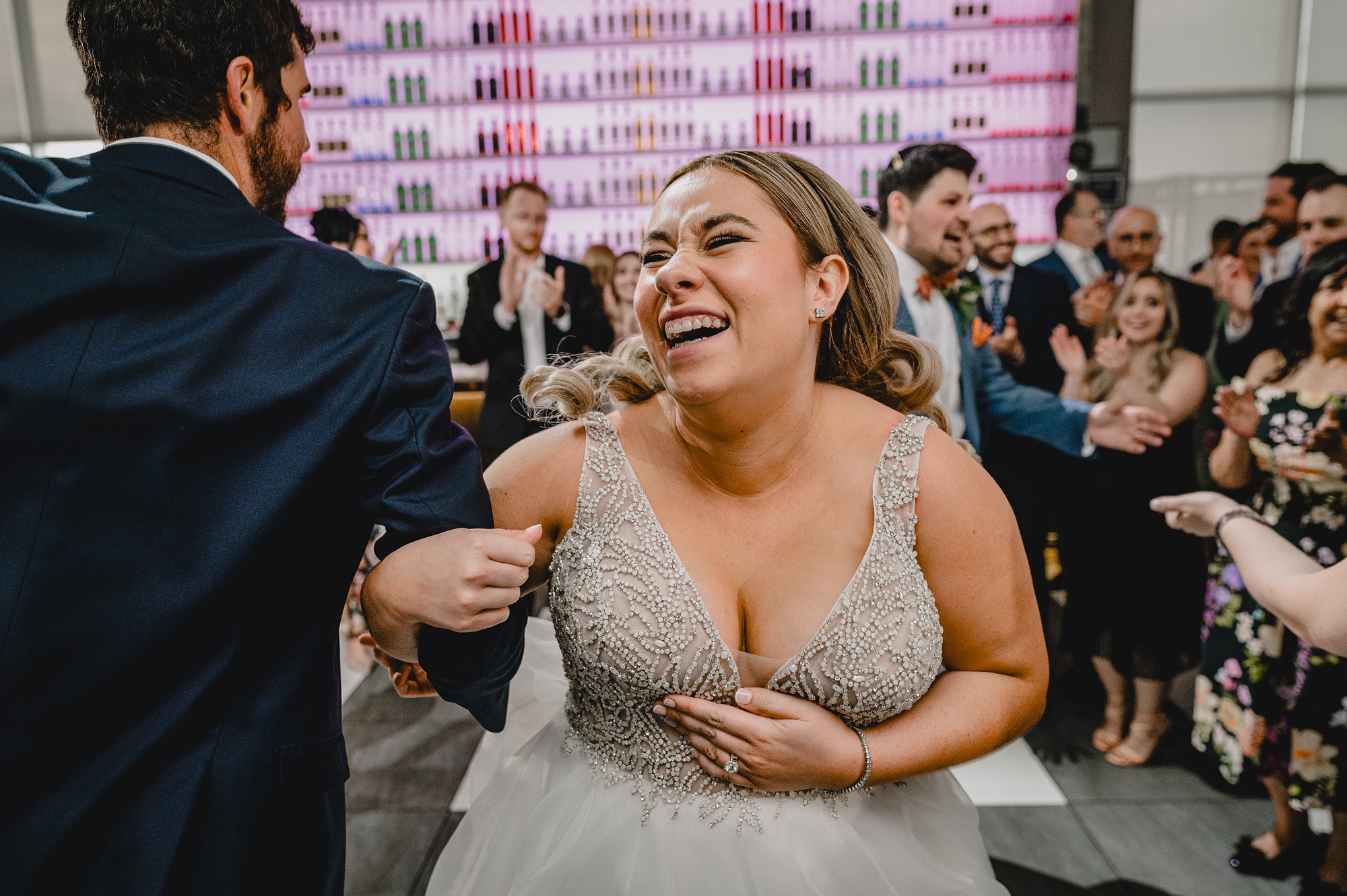 bride laughs with wedding guest during reception at Above Staten Island