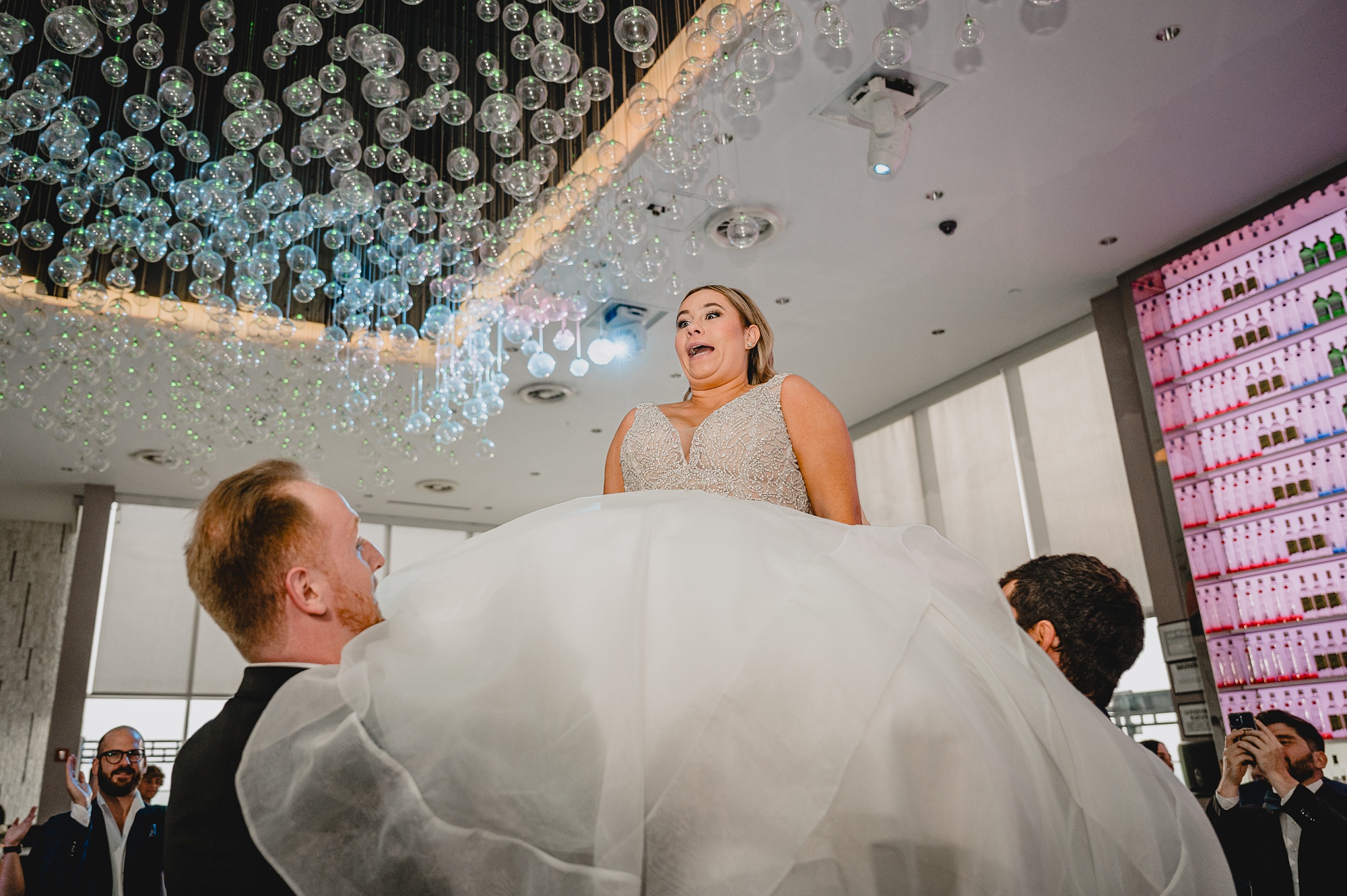 guests lift up bride during hora at Above Staten Island