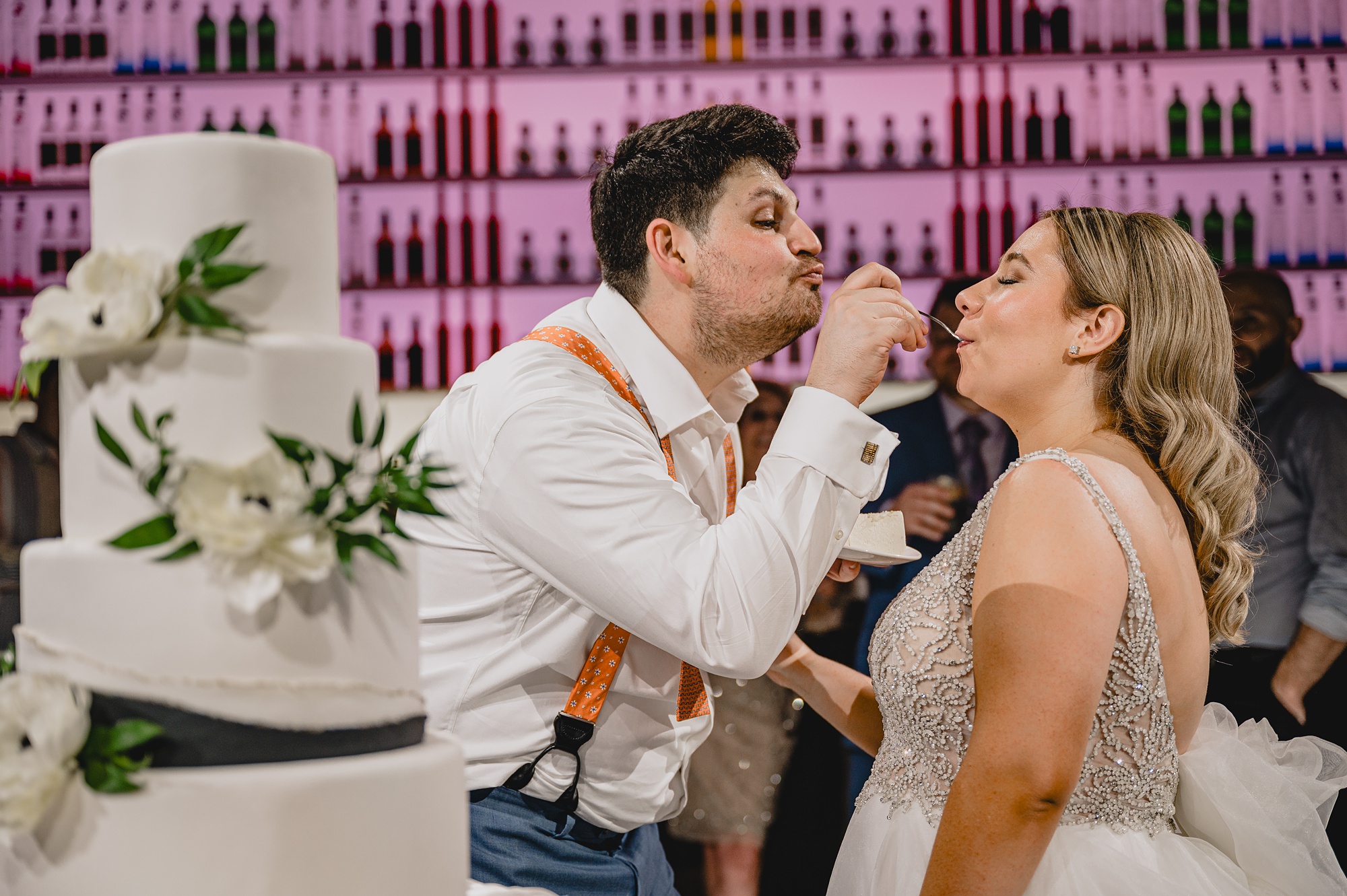 bride and groom feed each other cake at NY reception