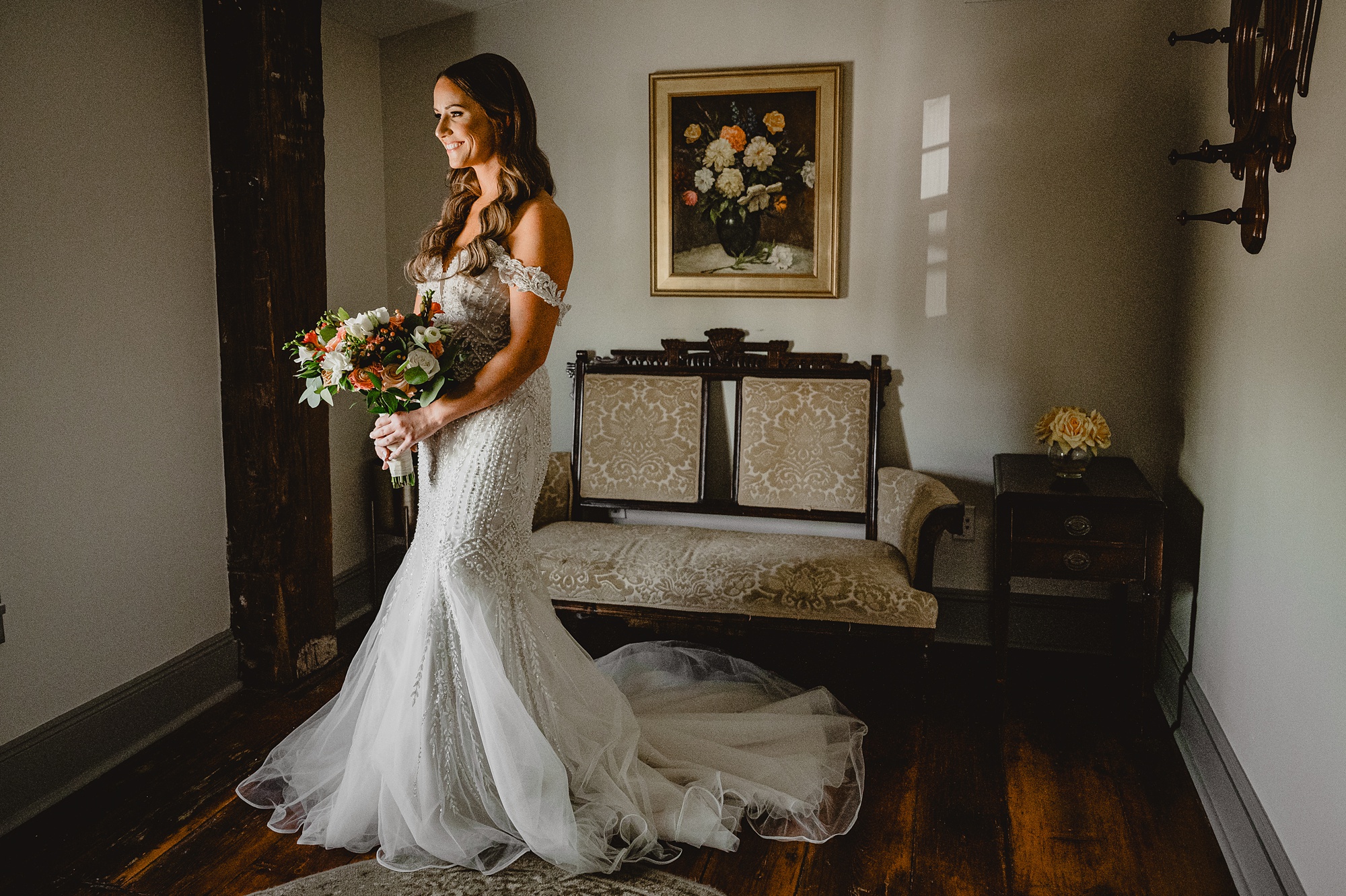 bride holds bouquet of flowers in suite at David's Country Inn