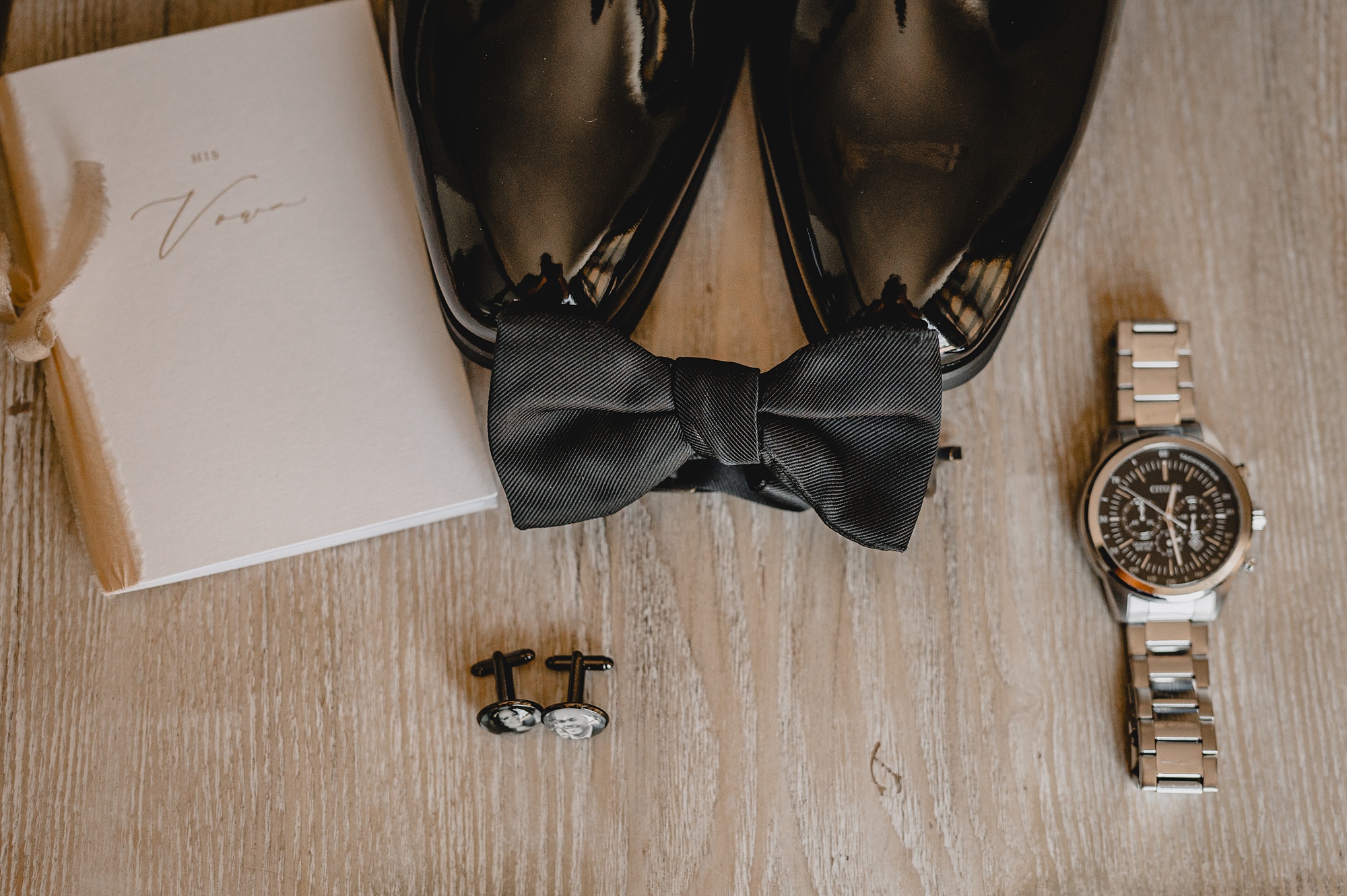 groom's black shoes with bowtie and gold watch
