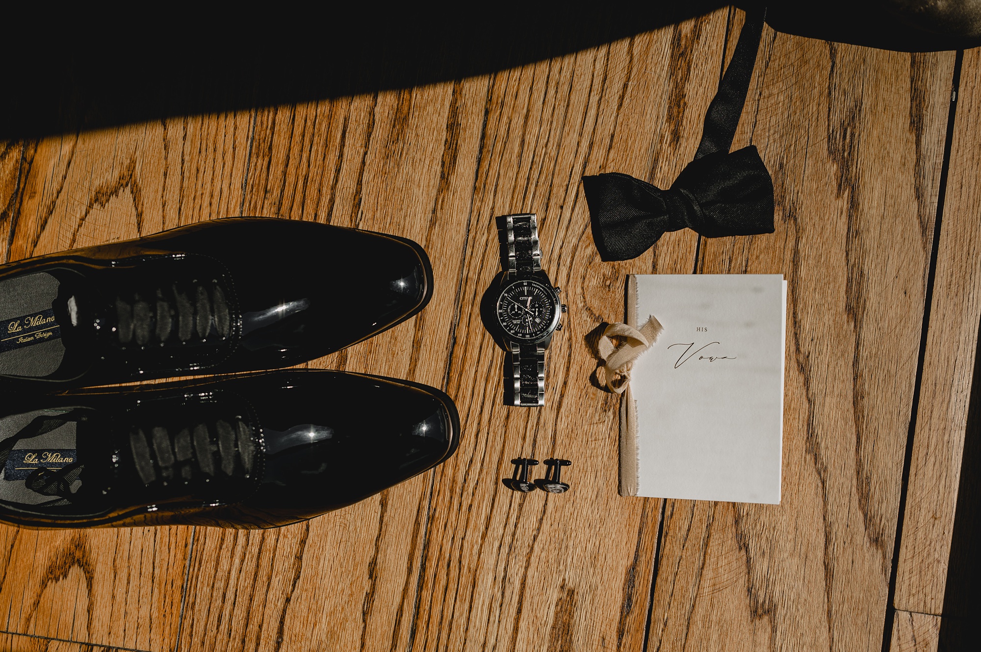 groom's black shoes, bow tie and gold watch