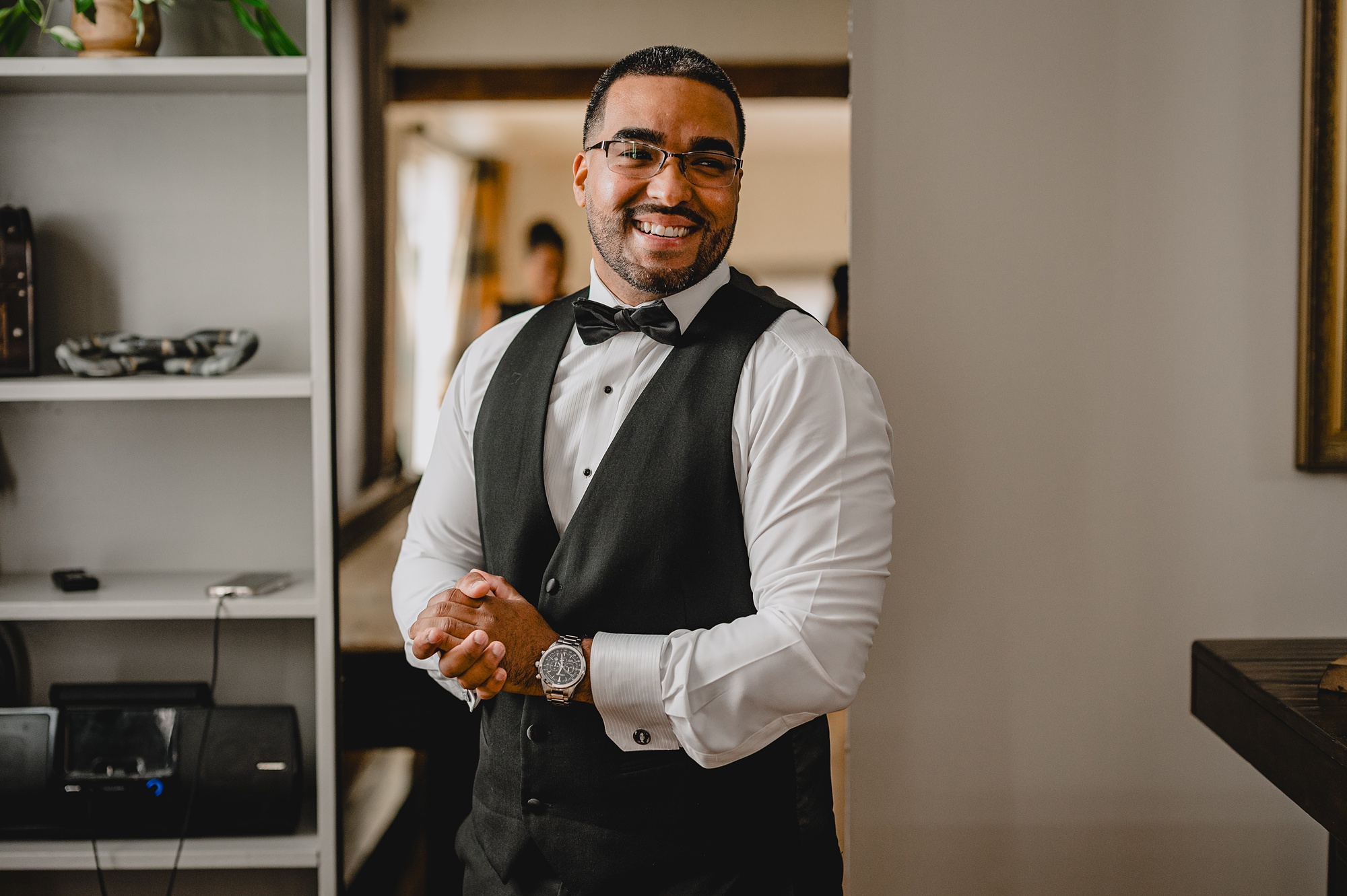 groom adjust cufflinks during prep in suite at David's Country Inn