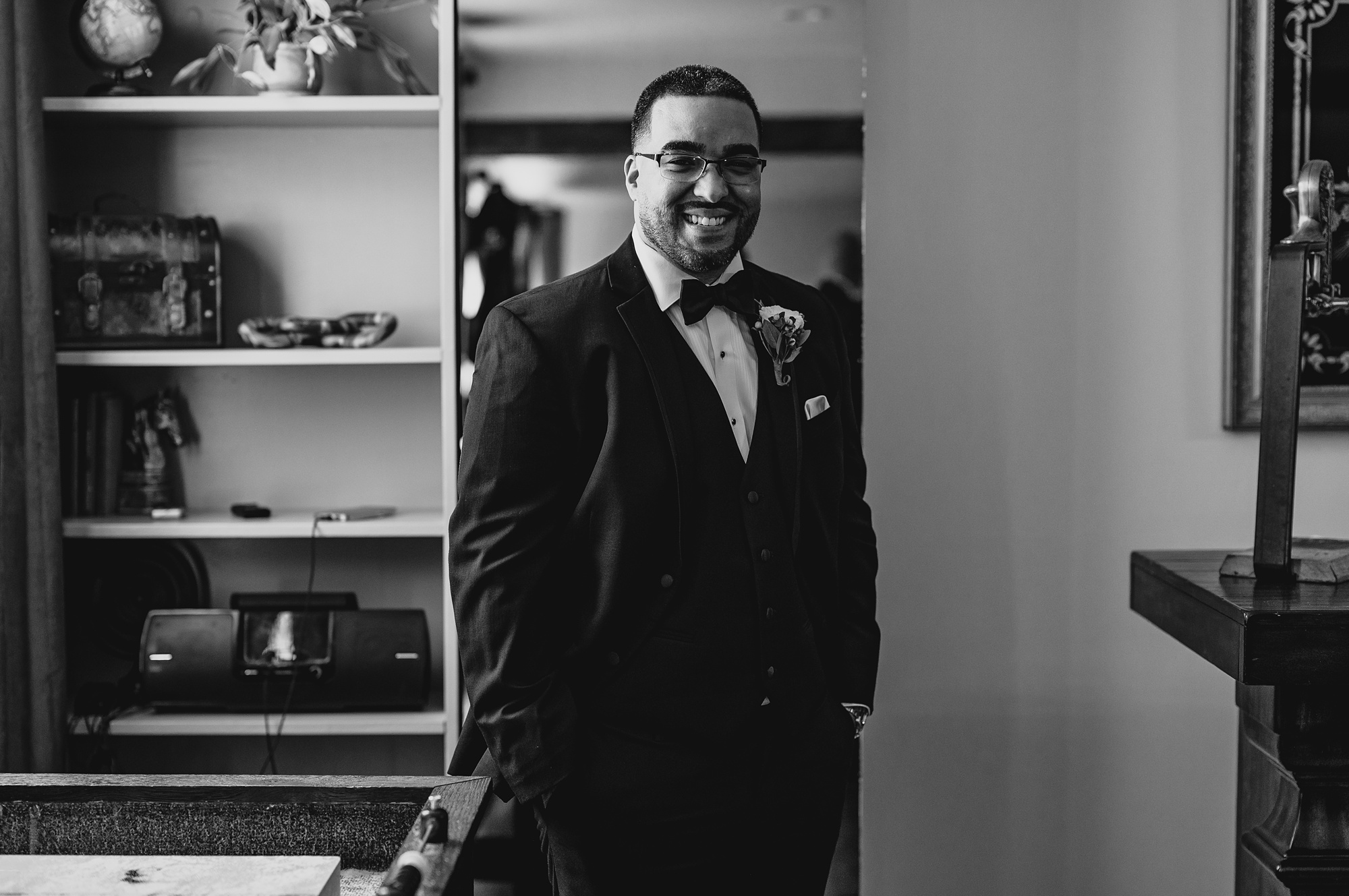 groom stands with hands in pockets of suit at David's Country Inn