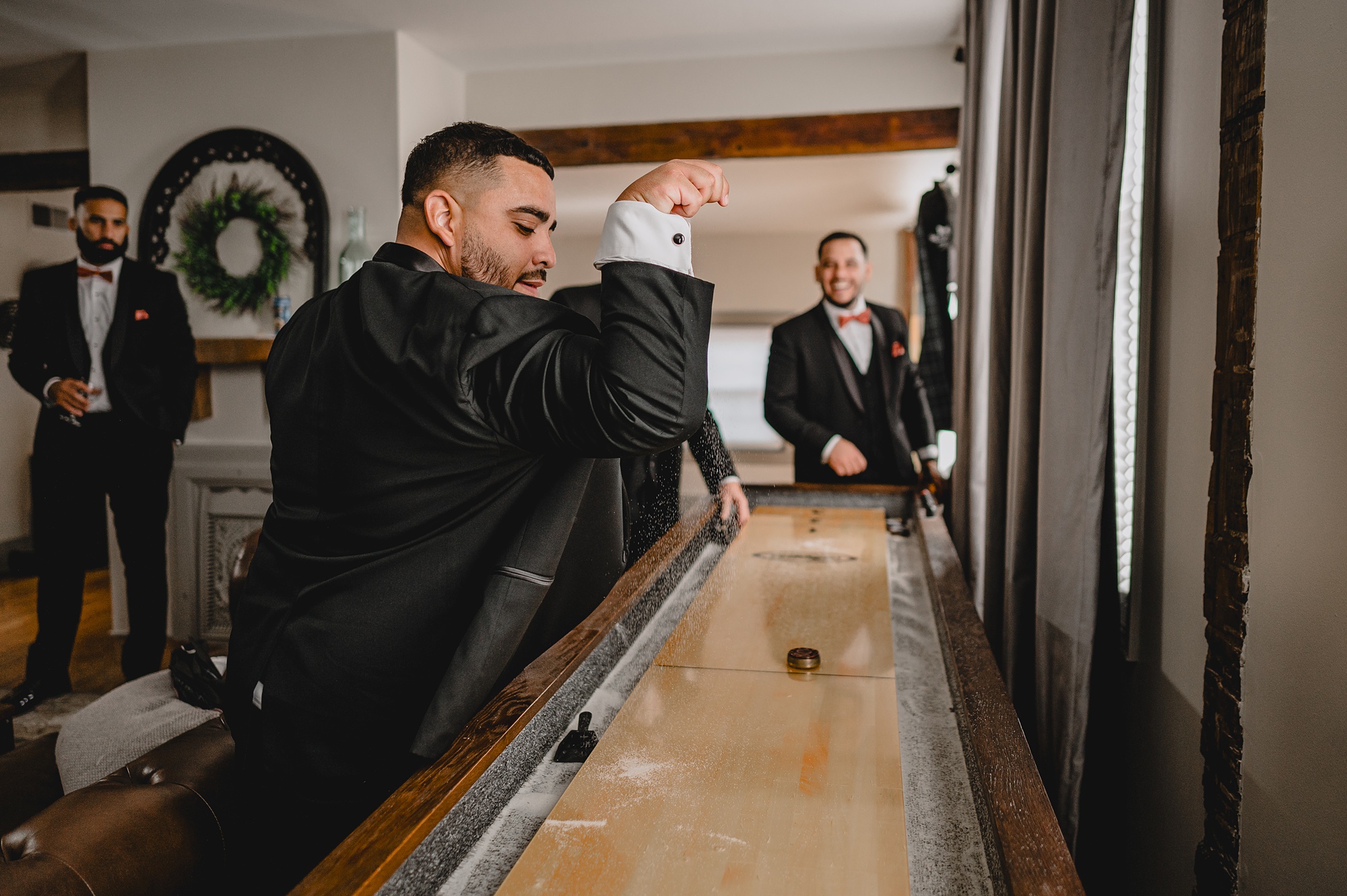 groomsmen play shuffleboard during prep at David's Country Inn