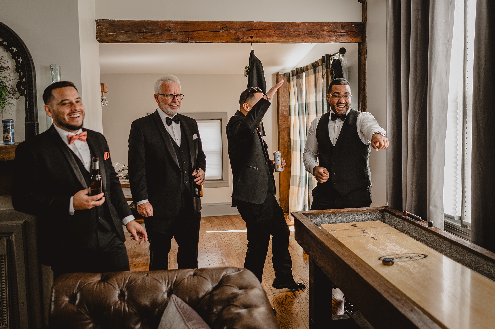 groom and groomsmen play shuffleboard on table at David's Country Inn