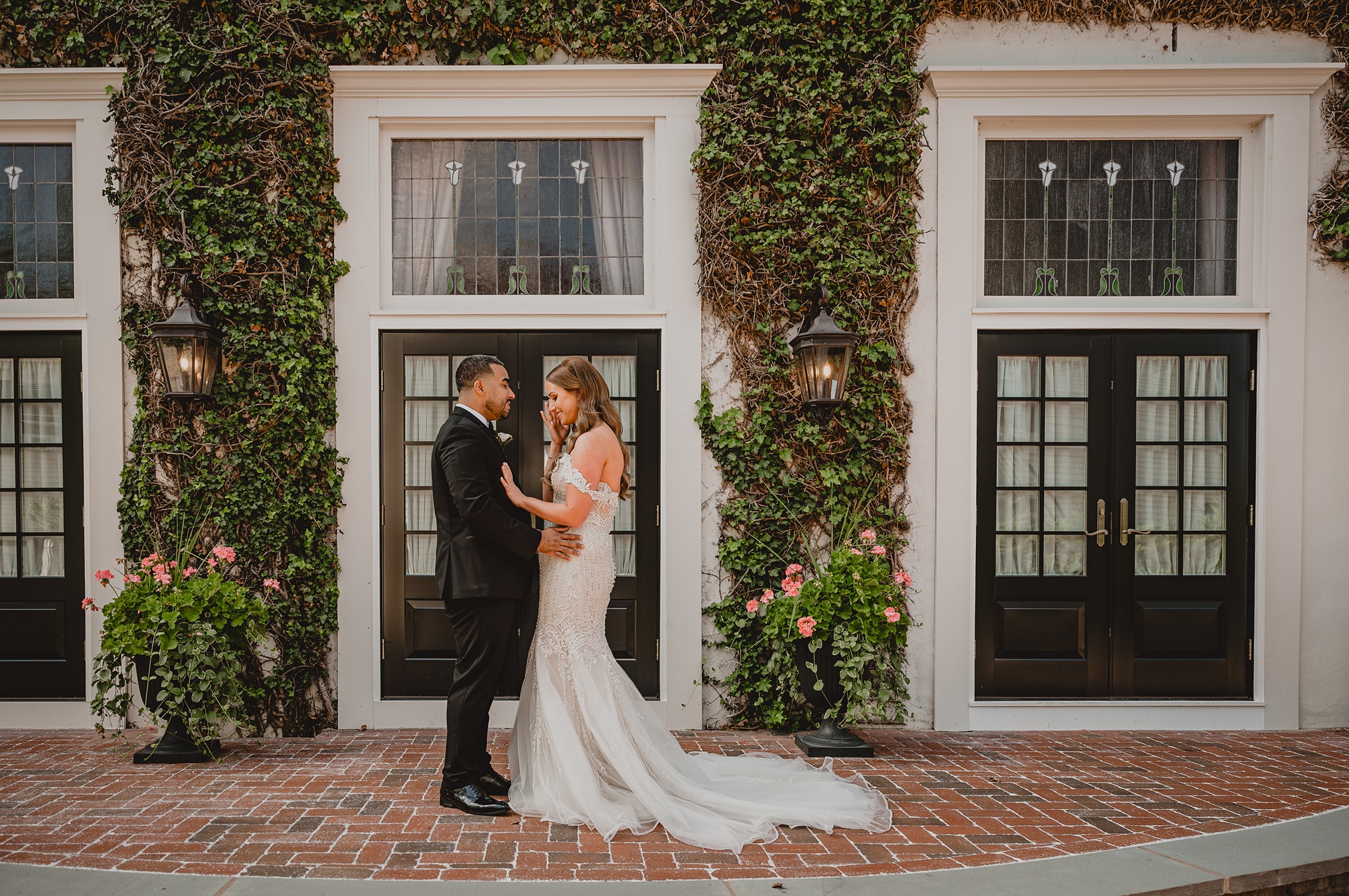bride and groom hug by white door at David's Country Inn